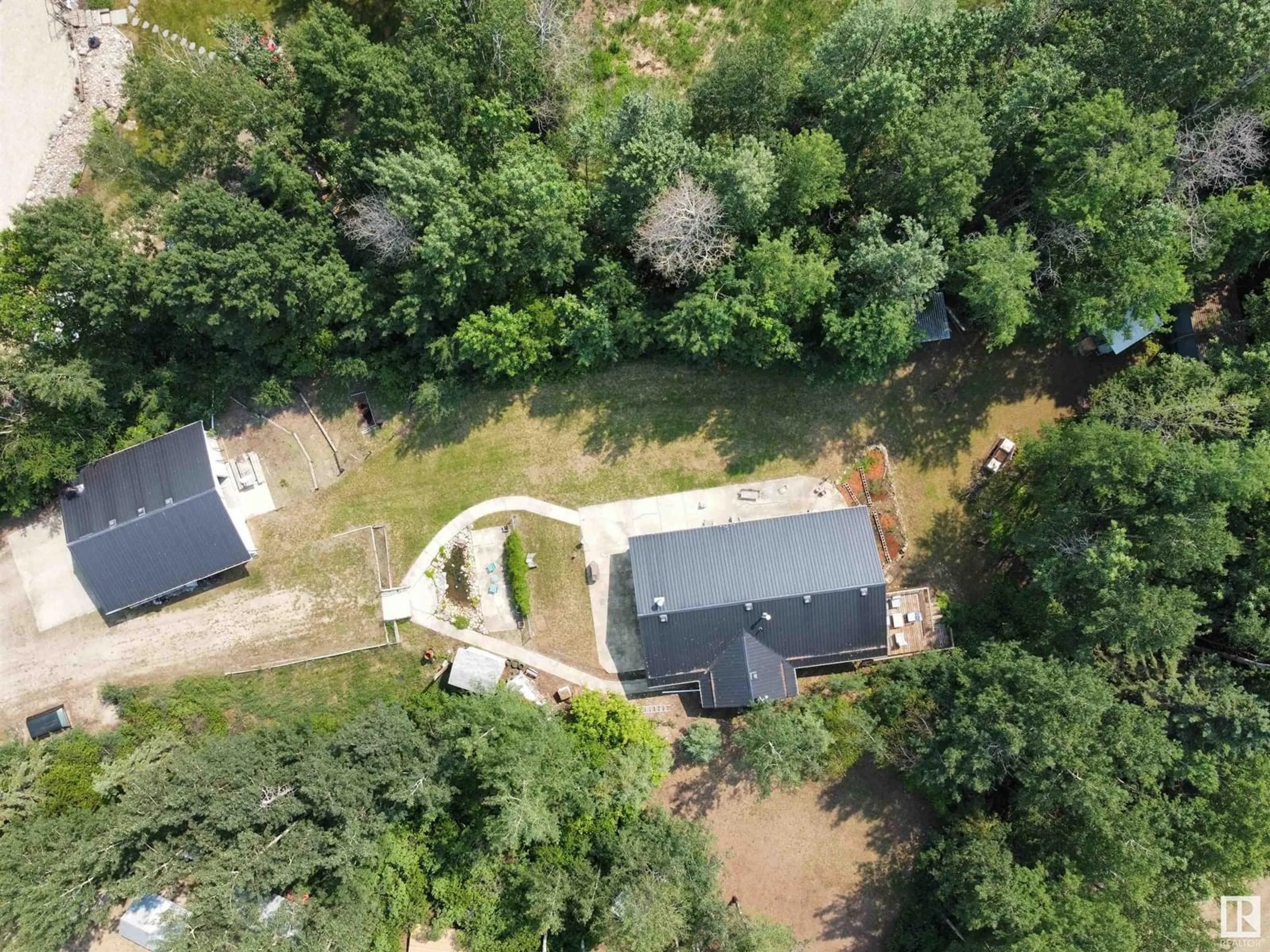 A pic from outside/outdoor area/front of a property/back of a property/a pic from drone, forest/trees view for 23 - 54126 RANGE ROAD 52, Rural Lac Ste. Anne County Alberta T0E0L0