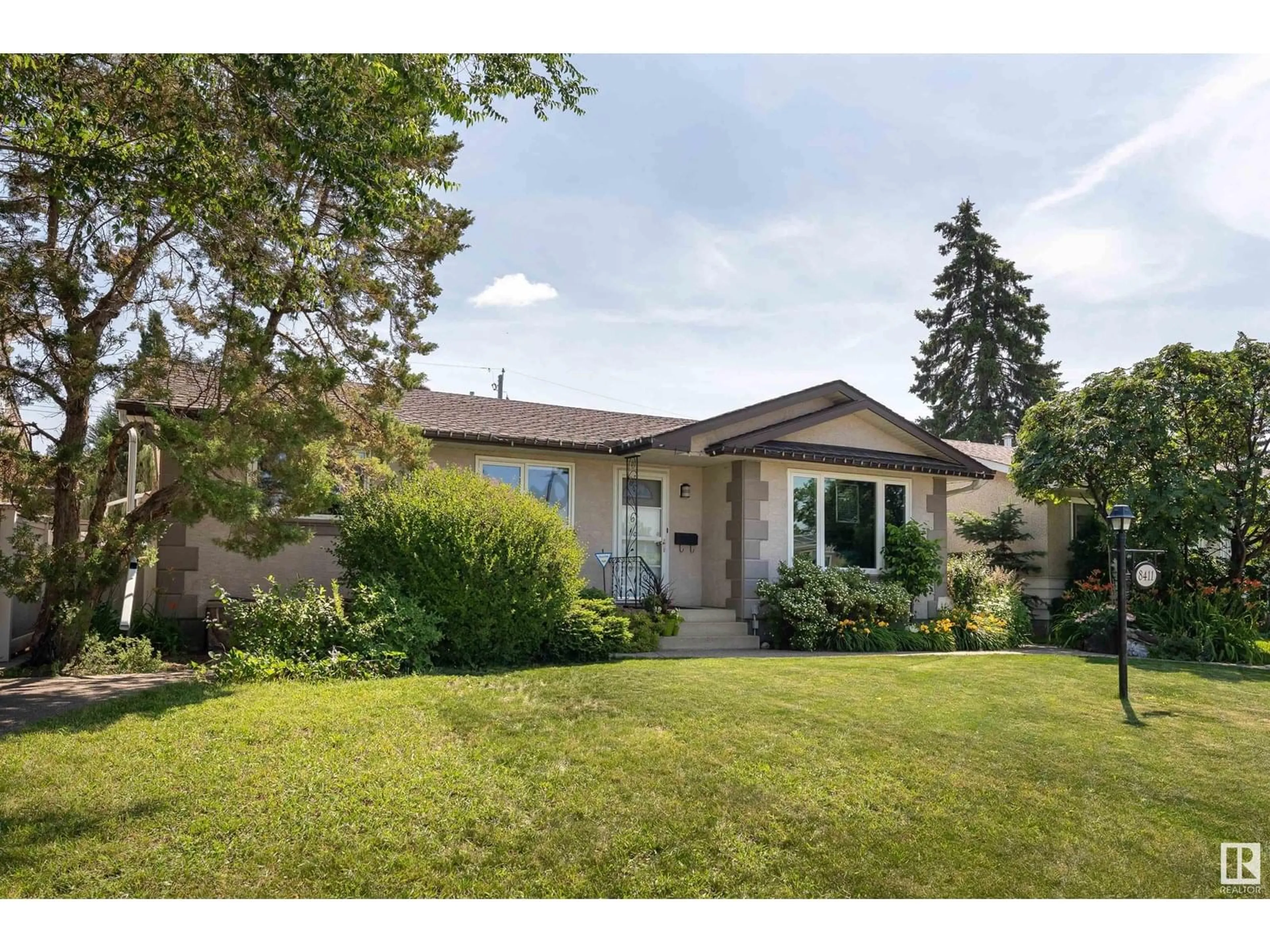 Home with vinyl exterior material, street for 8411 56 ST, Edmonton Alberta T6B1H8