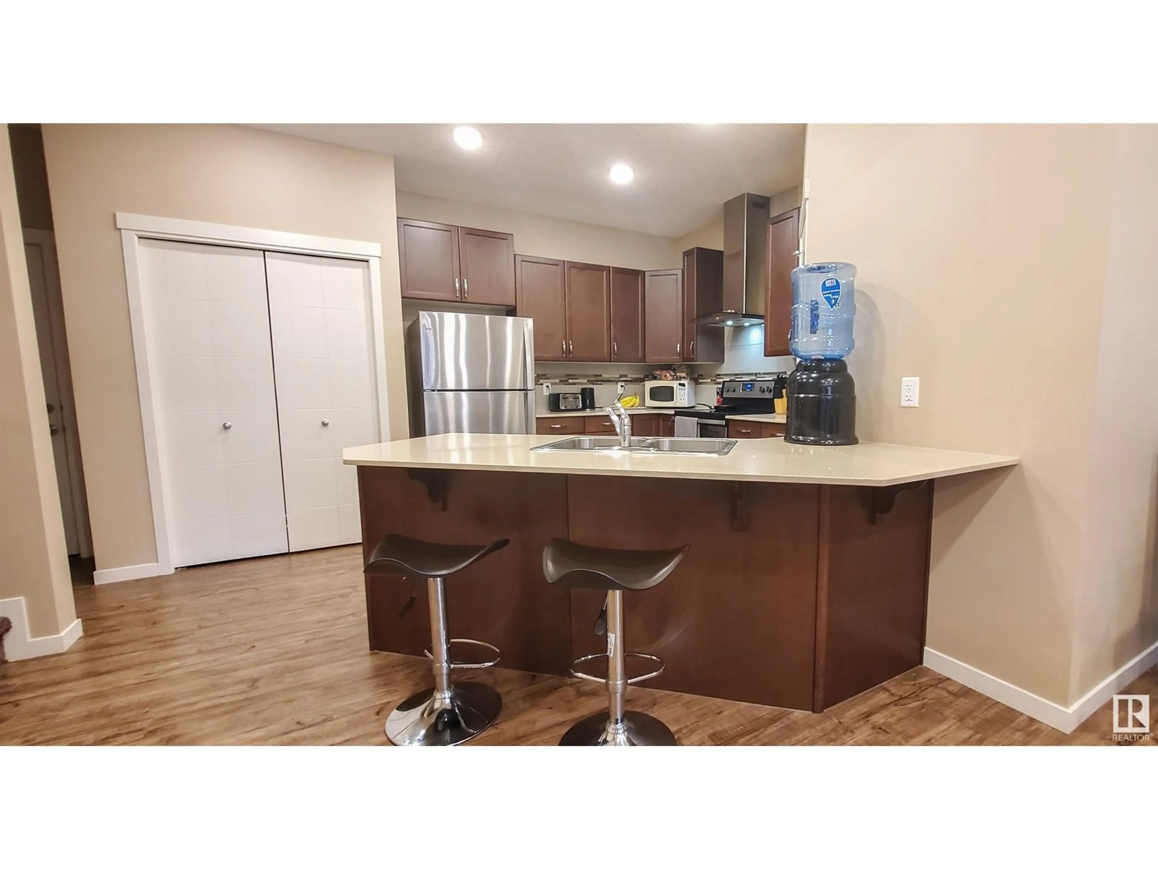 Open concept kitchen, wood/laminate floor for SW - 4436 ANNETT CM, Edmonton Alberta T6W2V9