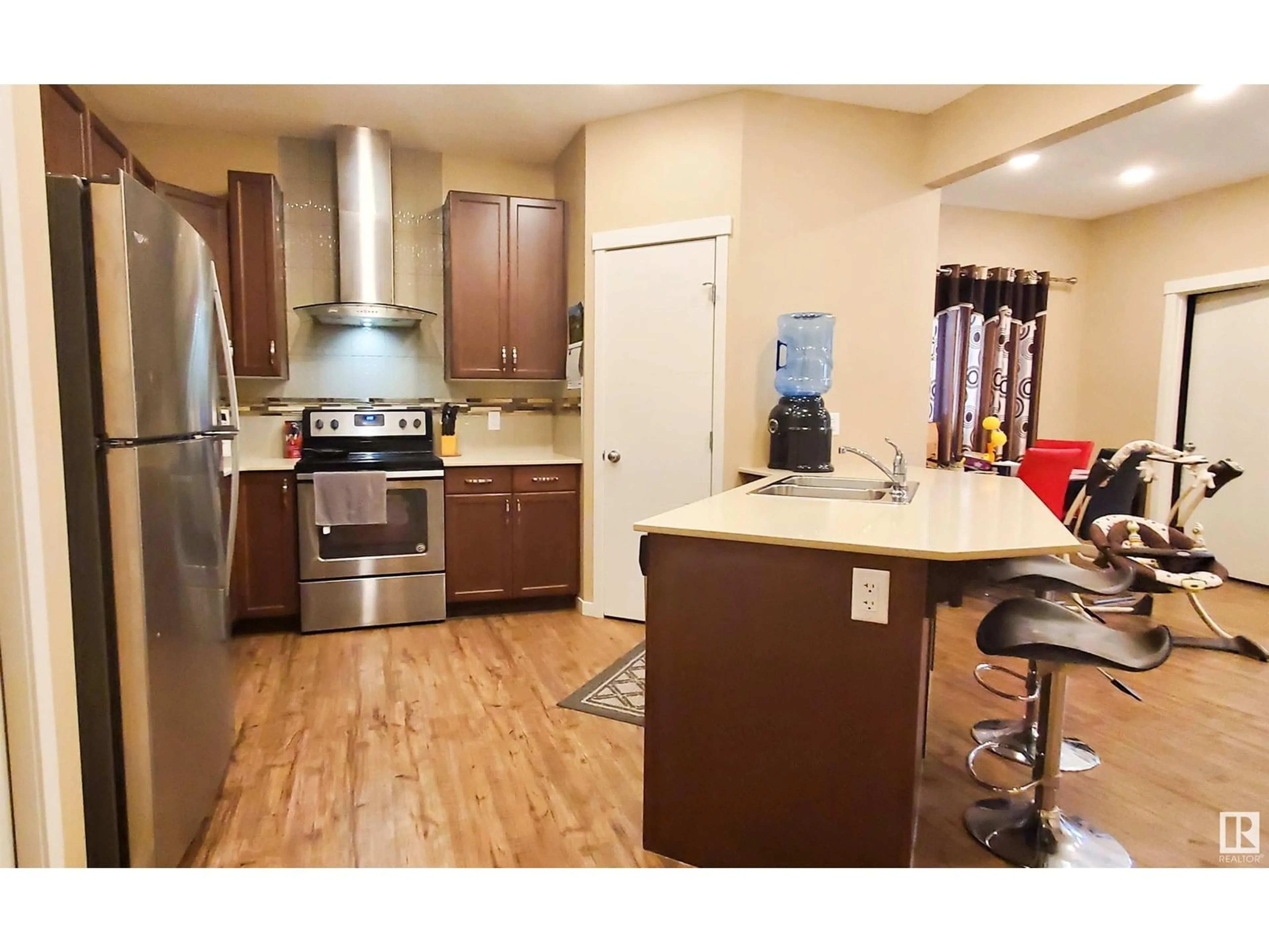 Open concept kitchen, wood/laminate floor for SW - 4436 ANNETT CM, Edmonton Alberta T6W2V9
