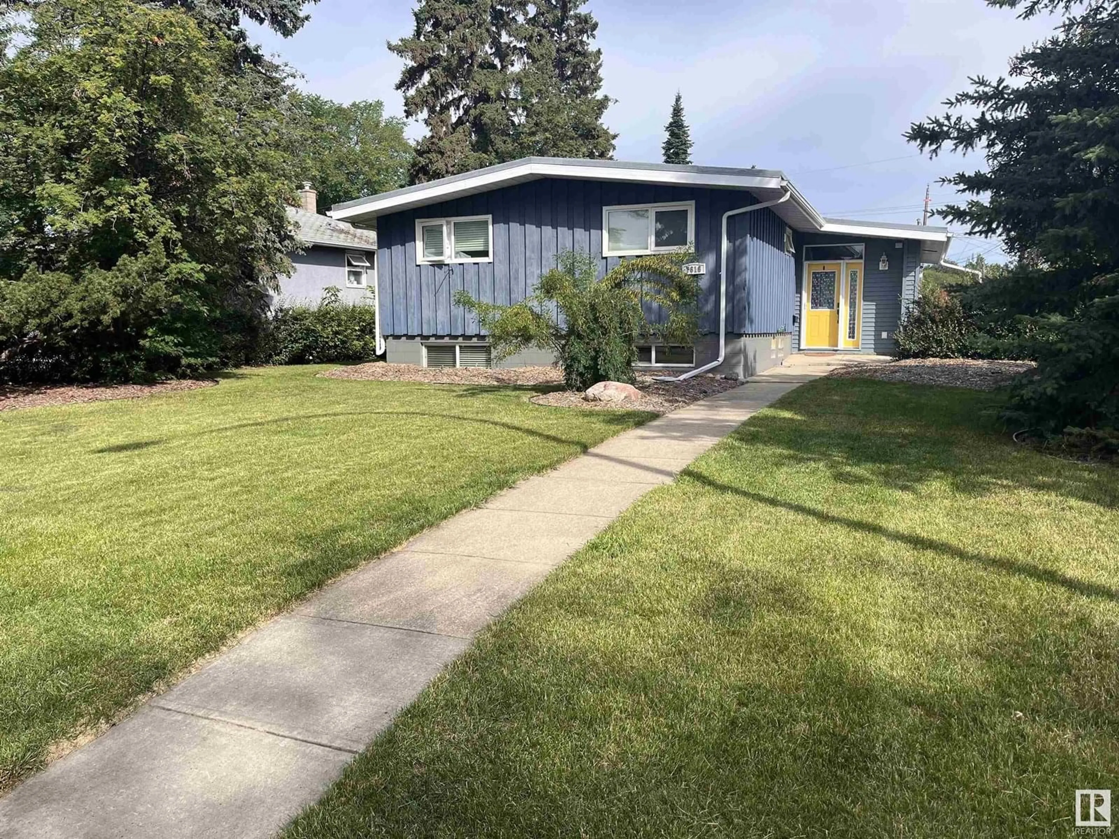 Home with vinyl exterior material, street for 7616 95 AV, Edmonton Alberta T6C1X7