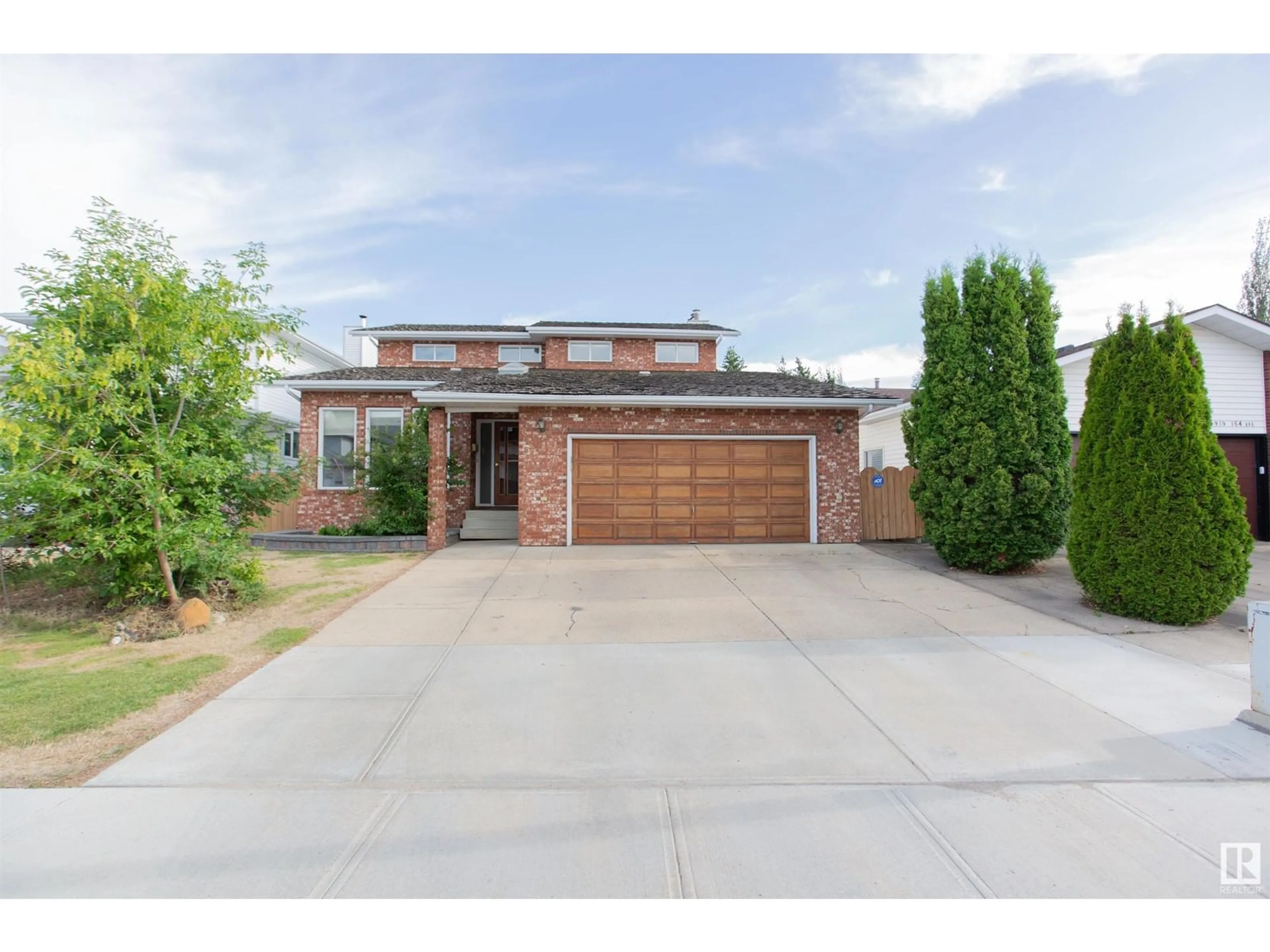 Home with brick exterior material, street for NW - 9915 154 AV, Edmonton Alberta T5X5R2