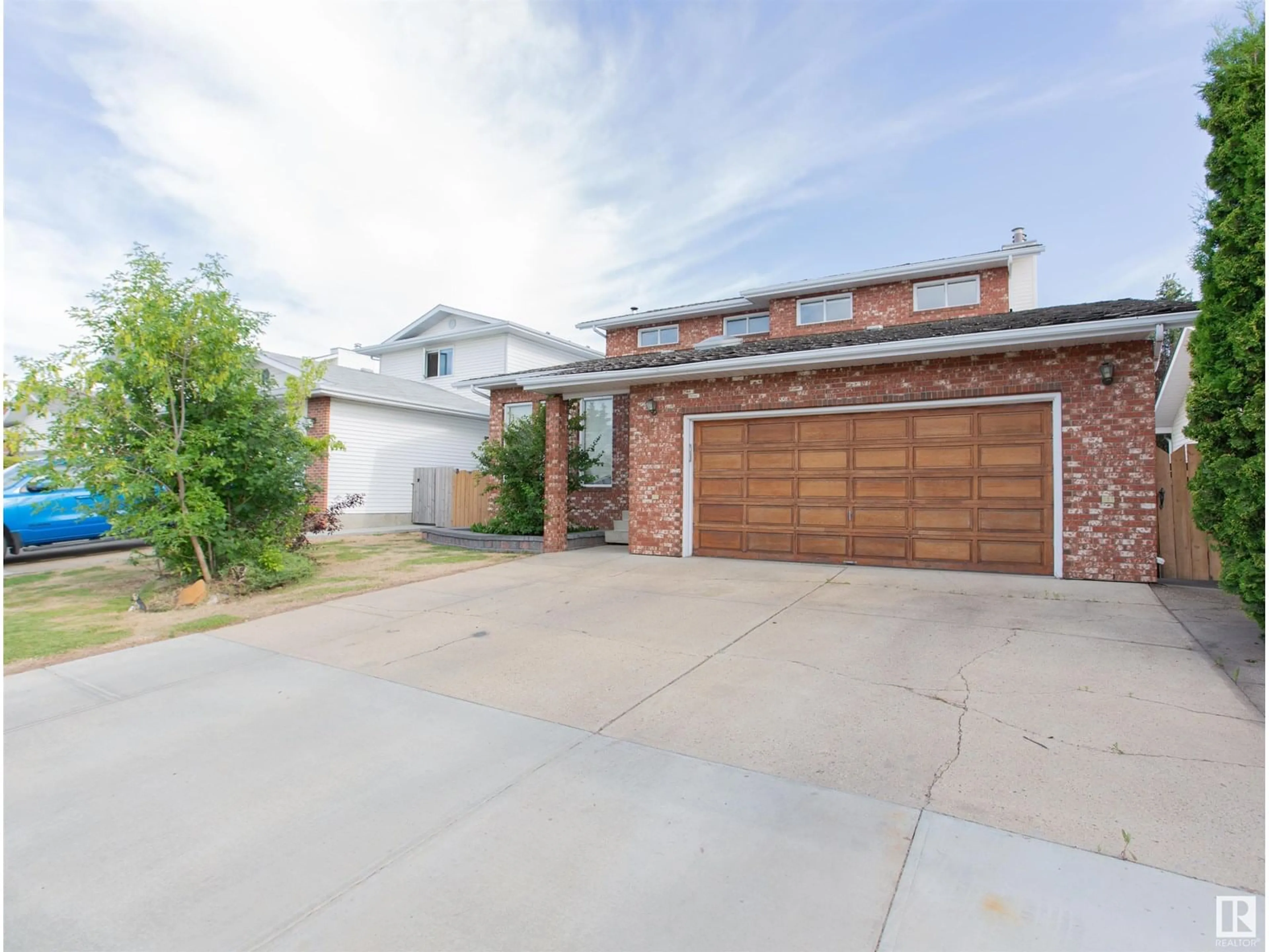 Home with brick exterior material, street for NW - 9915 154 AV, Edmonton Alberta T5X5R2