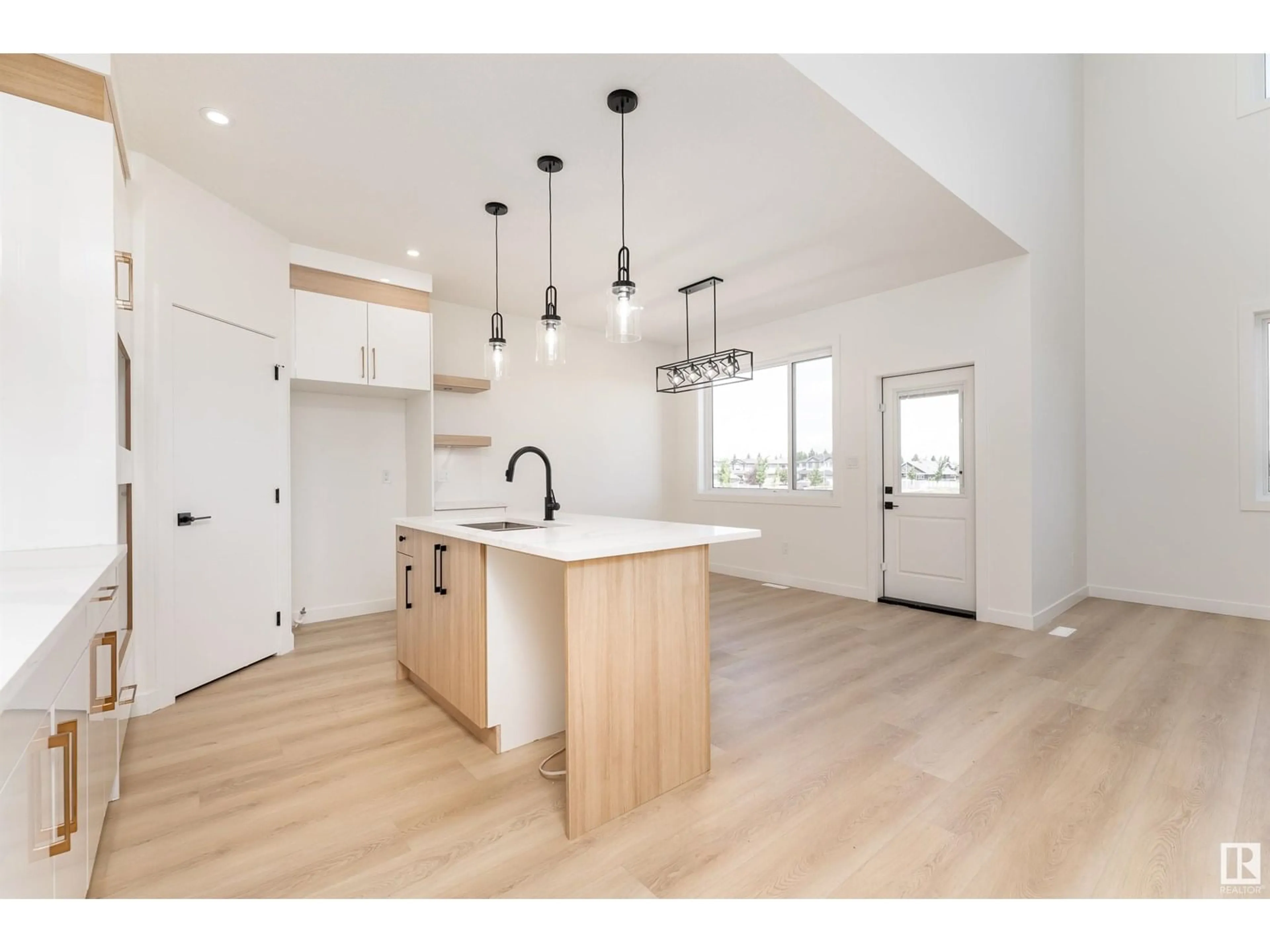 Open concept kitchen, wood/laminate floor for 76 HAZELWOOD LN, Spruce Grove Alberta T7X0R7