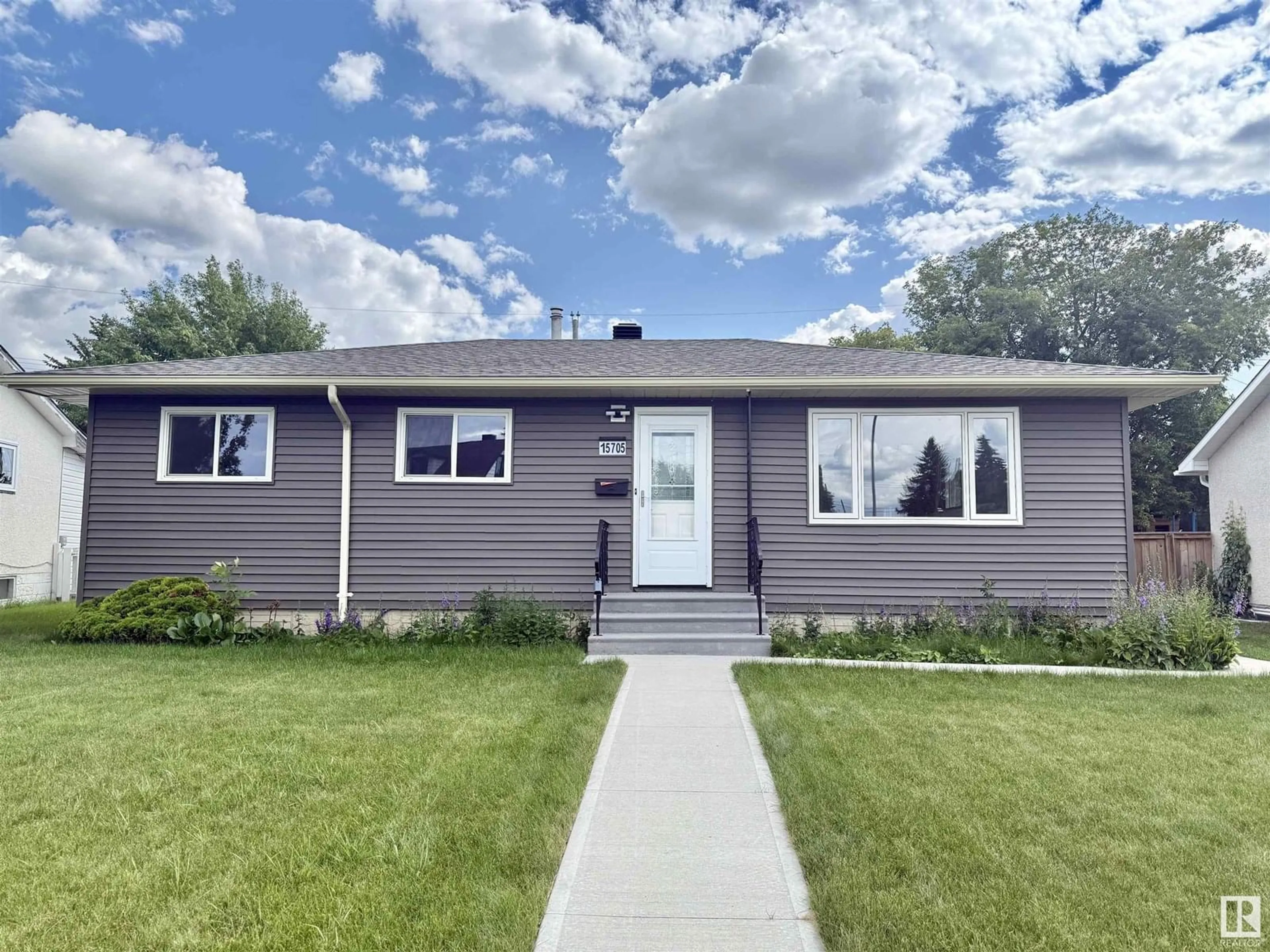 Home with vinyl exterior material, street for 15705 86 AV NW, Edmonton Alberta T5R4C5