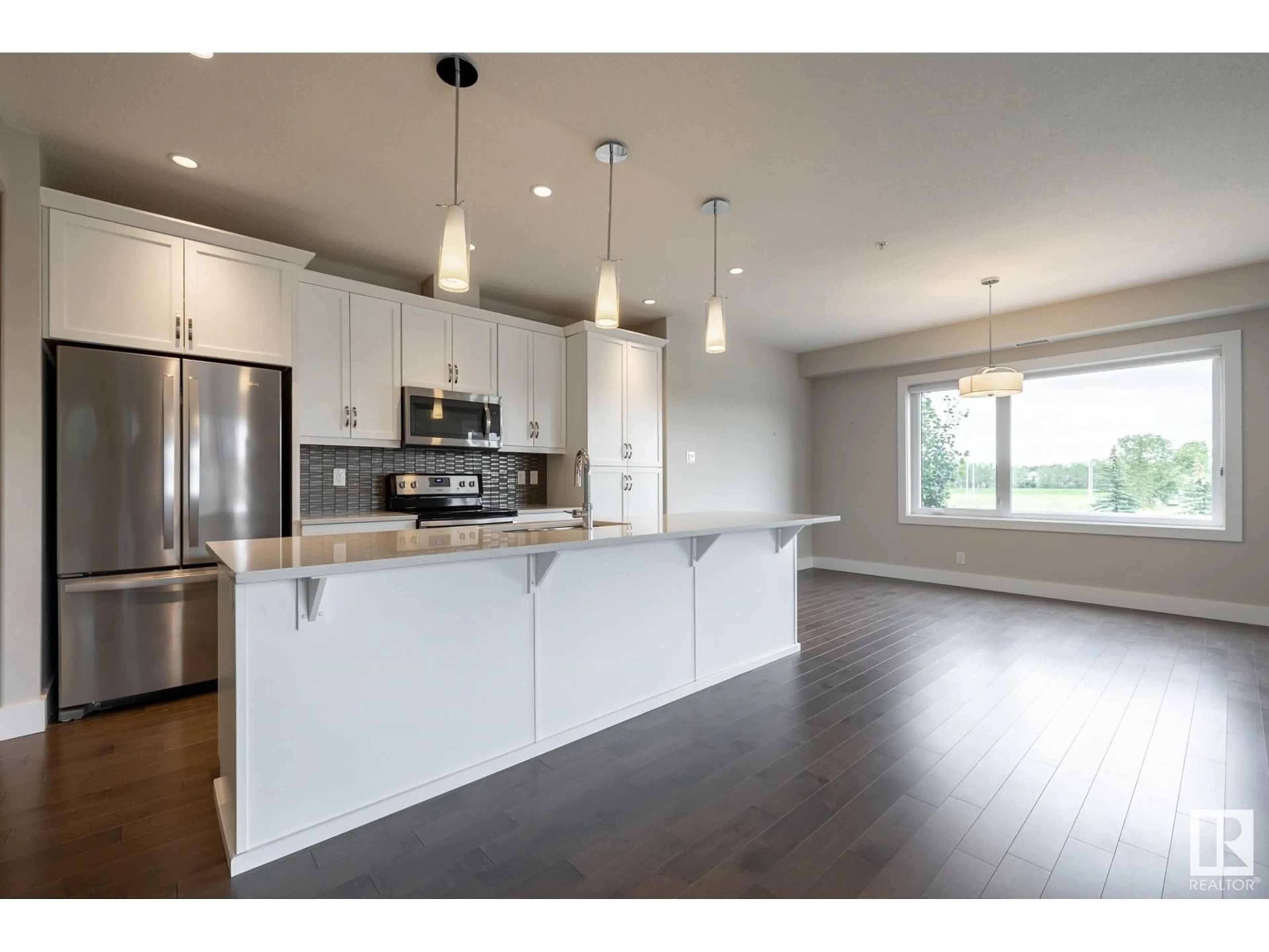 Open concept kitchen, wood/laminate floor for 232 - 11074 ELLERSLIE RD, Edmonton Alberta T6W2C2