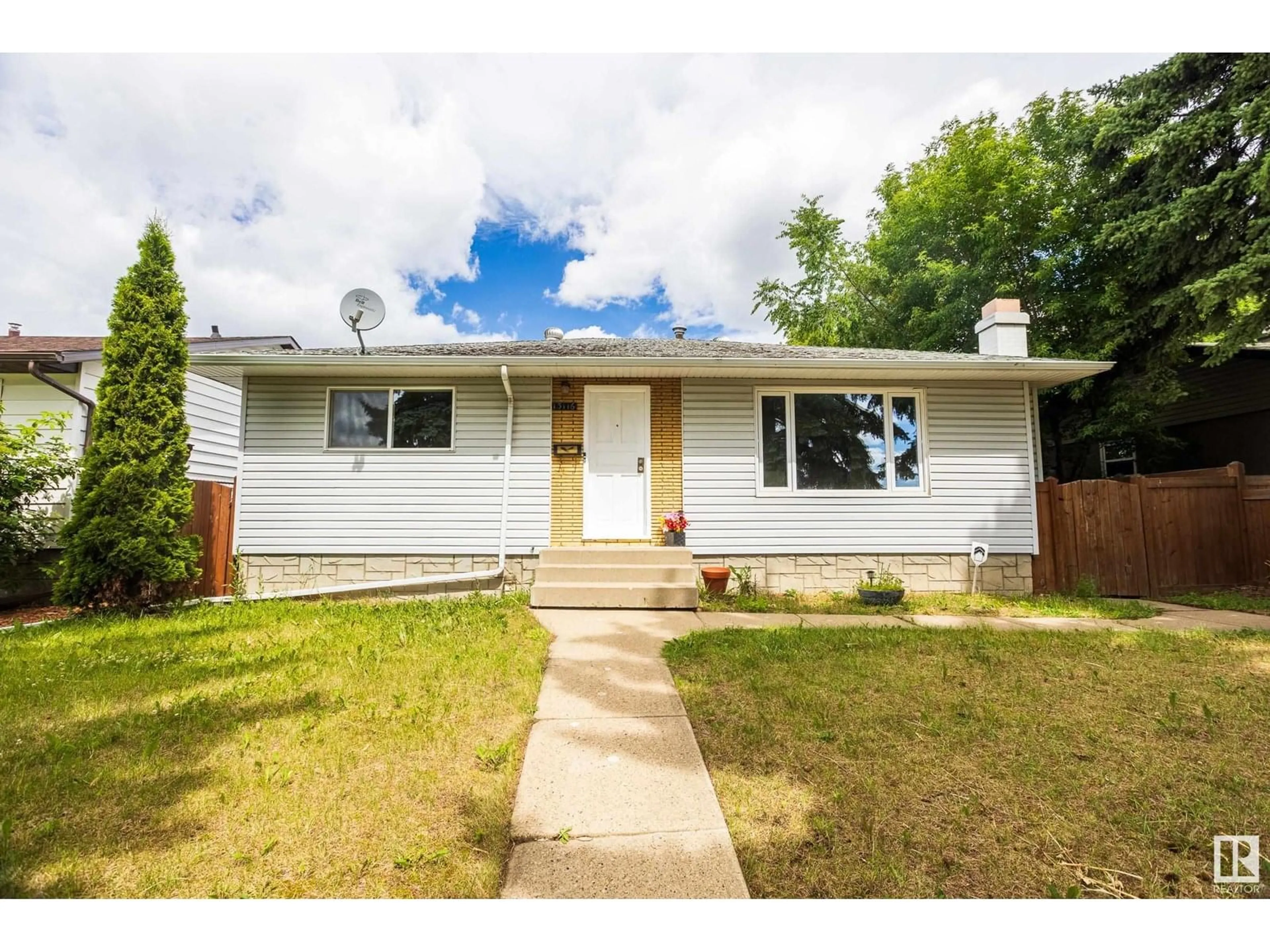 Home with vinyl exterior material, street for 13116 136 AV, Edmonton Alberta T5L4B3