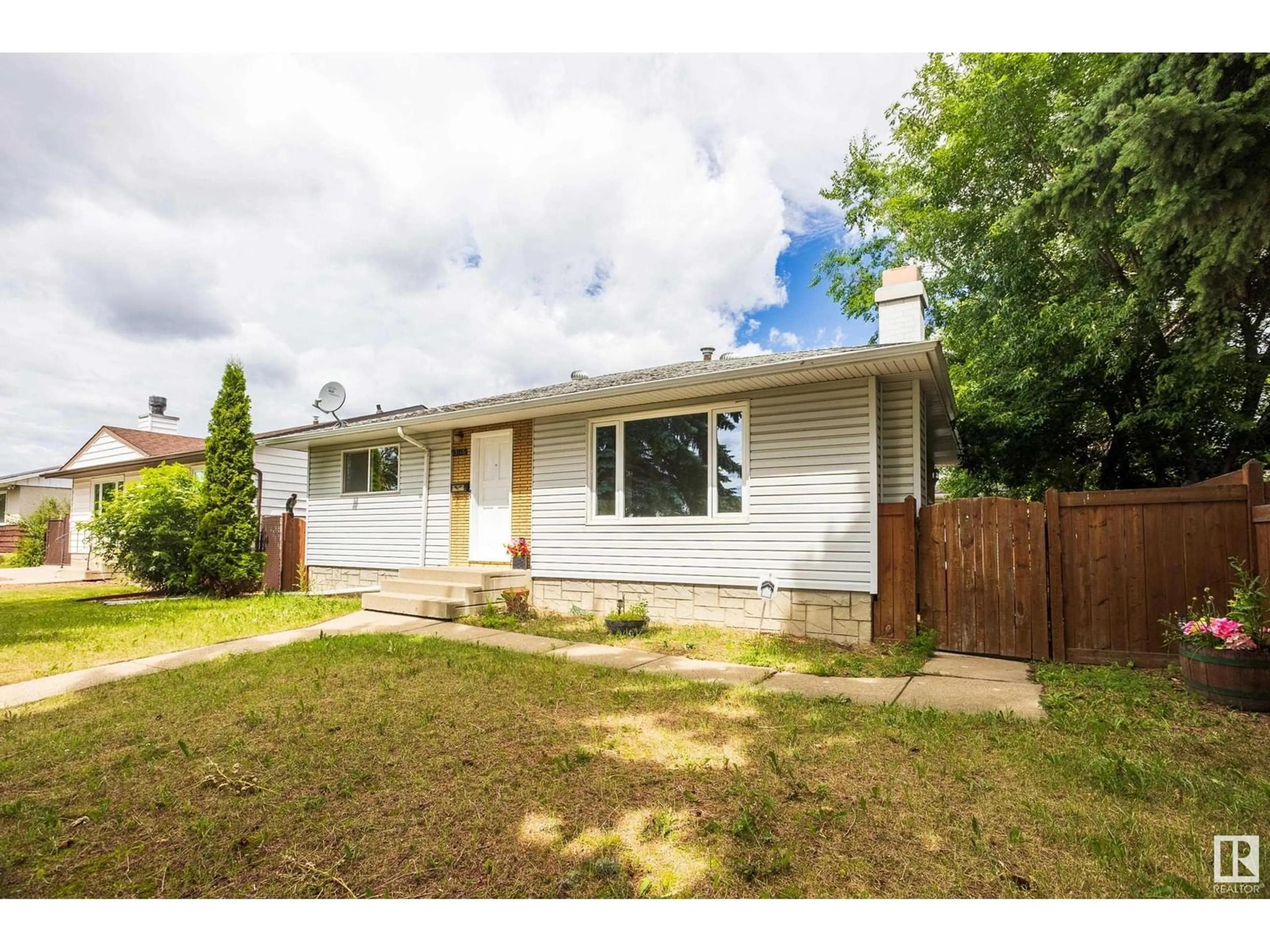 Home with vinyl exterior material, street for 13116 136 AV, Edmonton Alberta T5L4B3