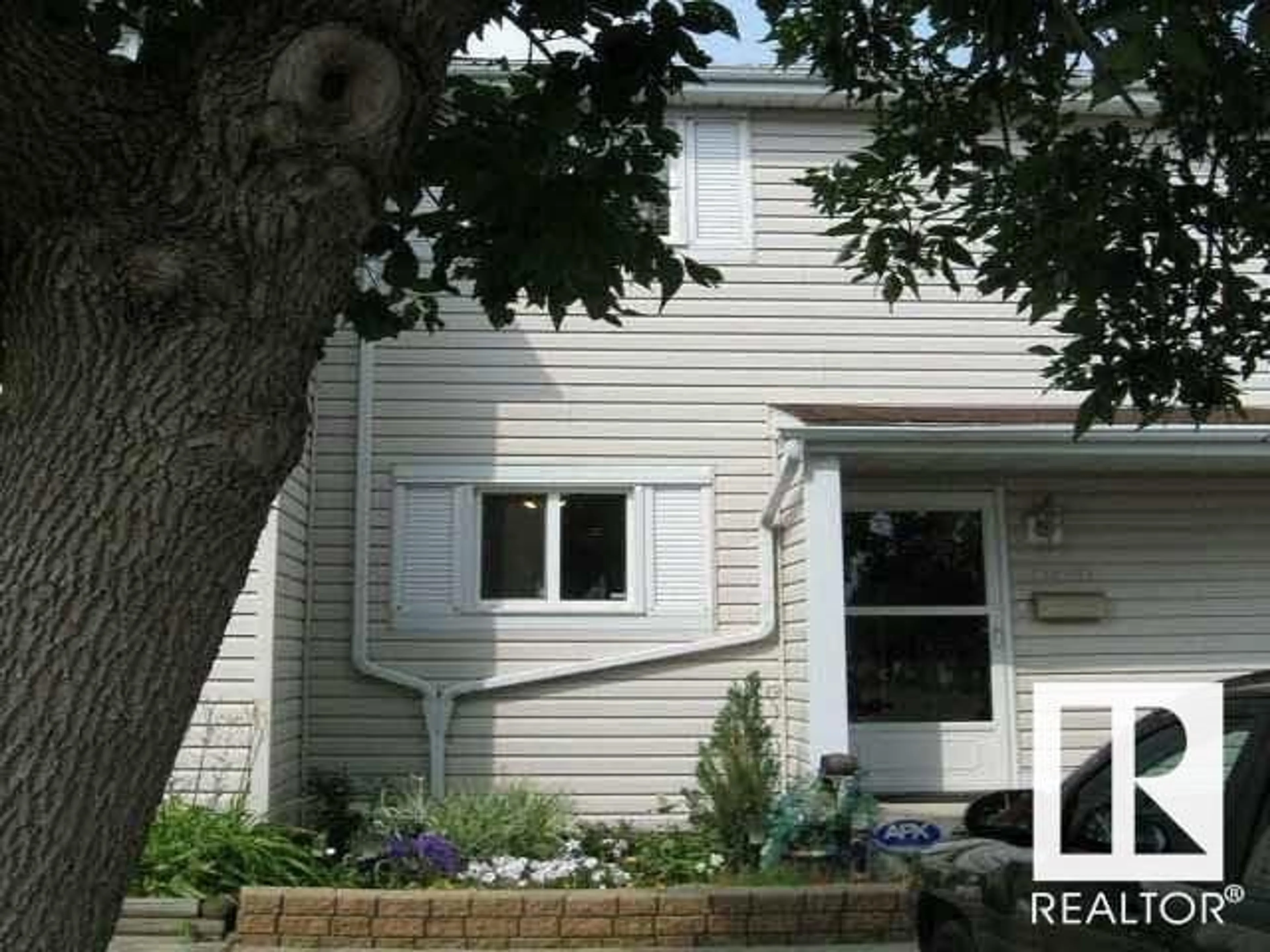 Home with vinyl exterior material, street for 11406 139 AV, Edmonton Alberta T5X3L4