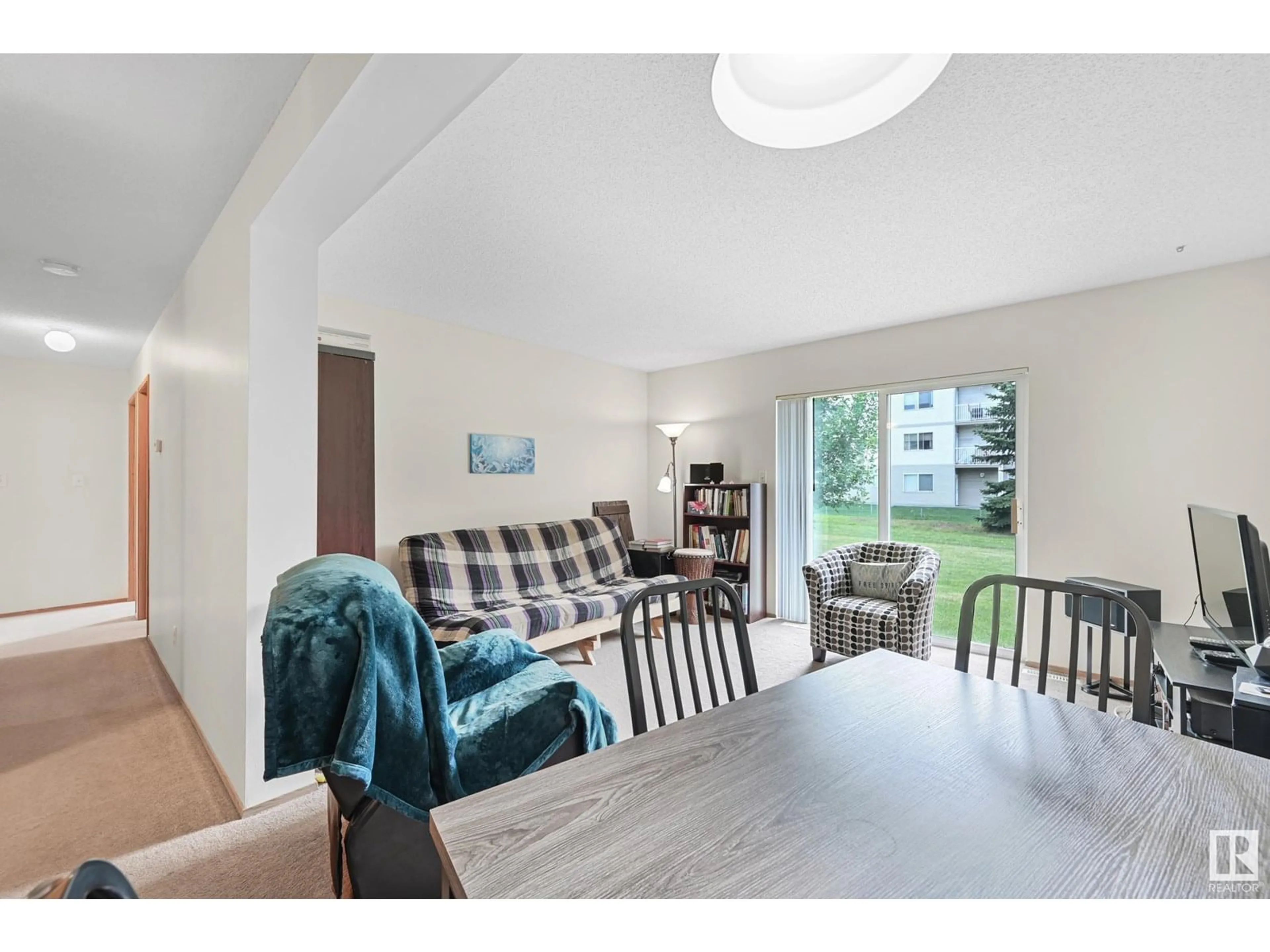 Living room with furniture, wood/laminate floor for #104A - 110 WESTPARK DR, Fort Saskatchewan Alberta T8L4M2