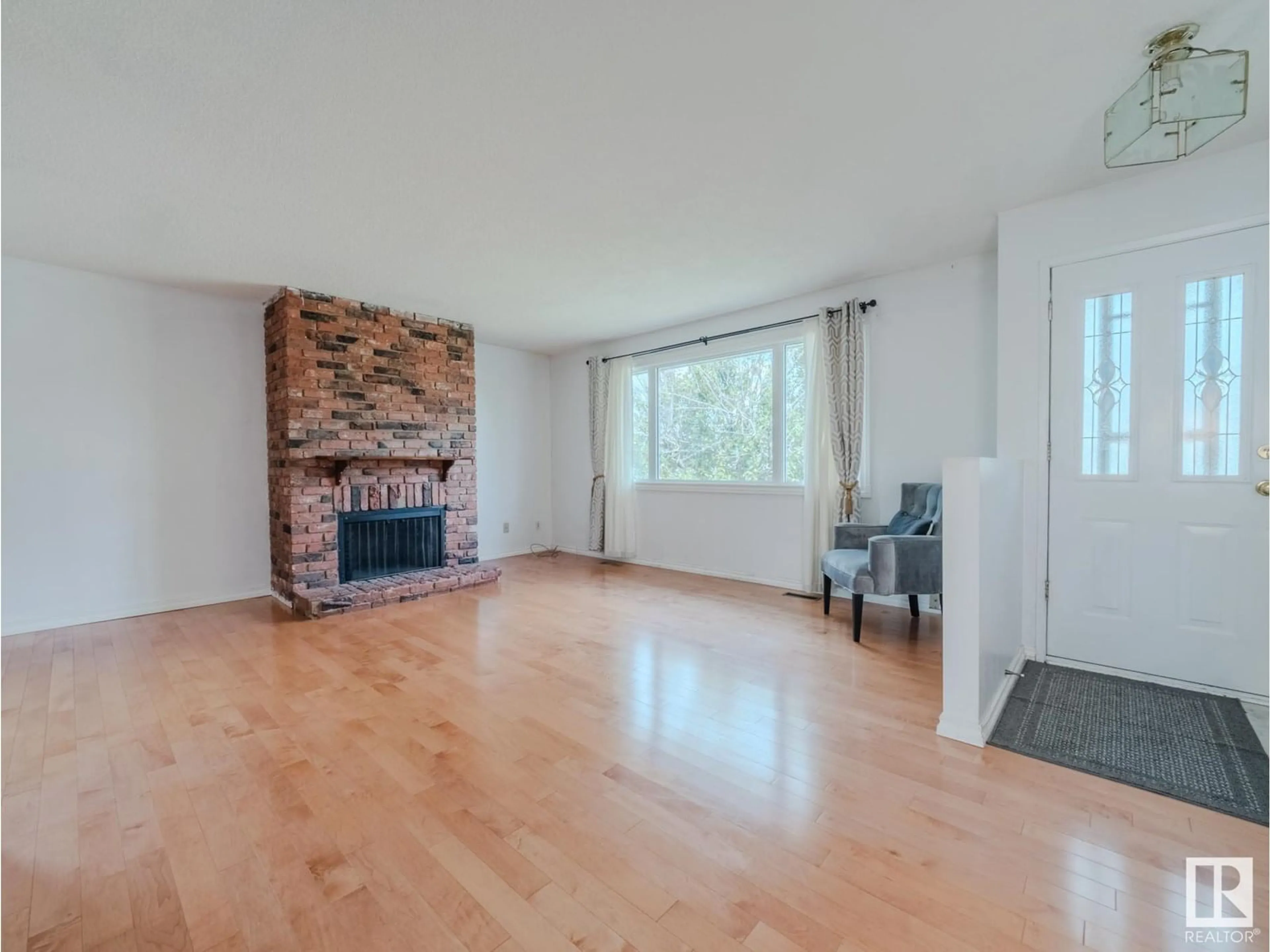 Living room with furniture, wood/laminate floor for 4705 128A AV, Edmonton Alberta T5A2J4