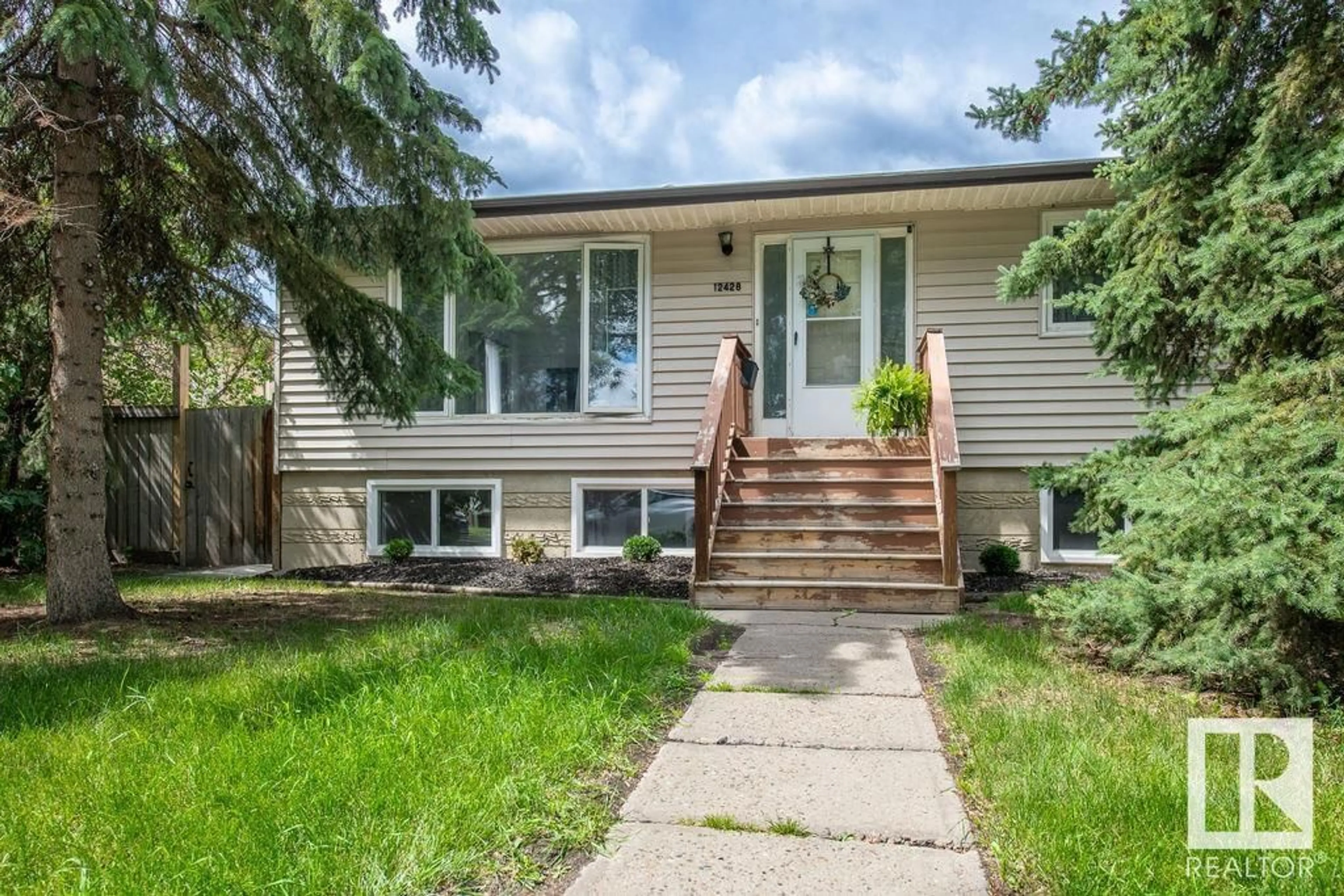 Home with vinyl exterior material, street for 12428 90 ST NW, Edmonton Alberta T5B3Z8