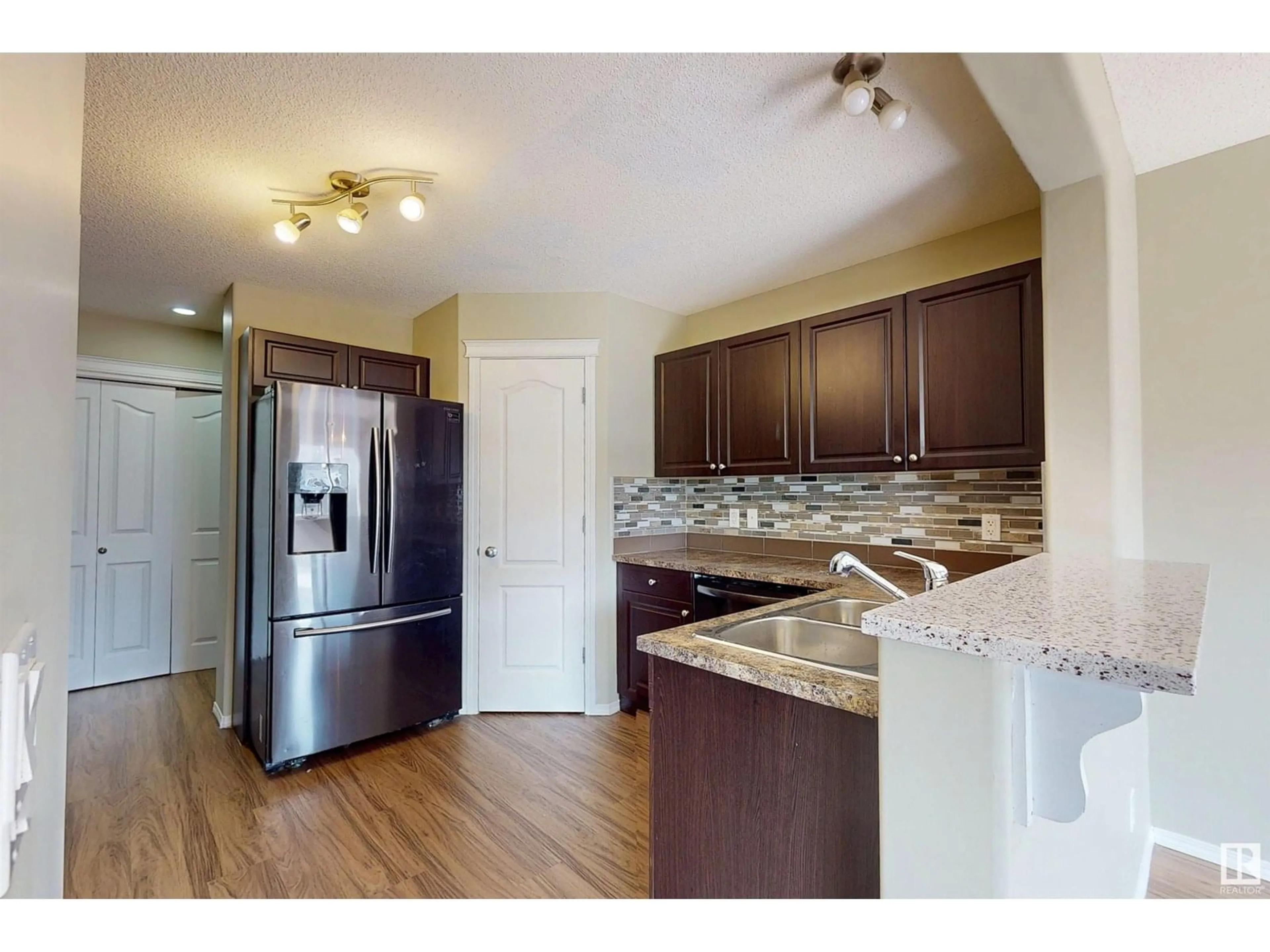 Open concept kitchen, wood/laminate floor for 2931 26 AVE, Edmonton Alberta T6T0H6