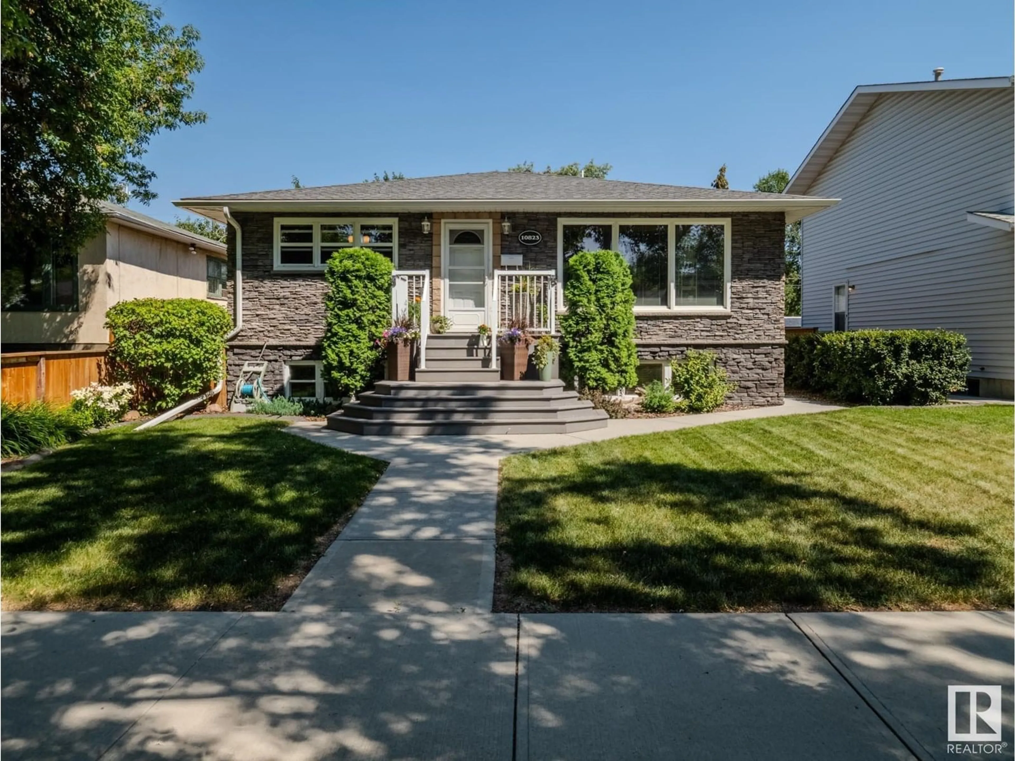 Home with vinyl exterior material, street for NW - 10823 122 ST, Edmonton Alberta T5M0A5