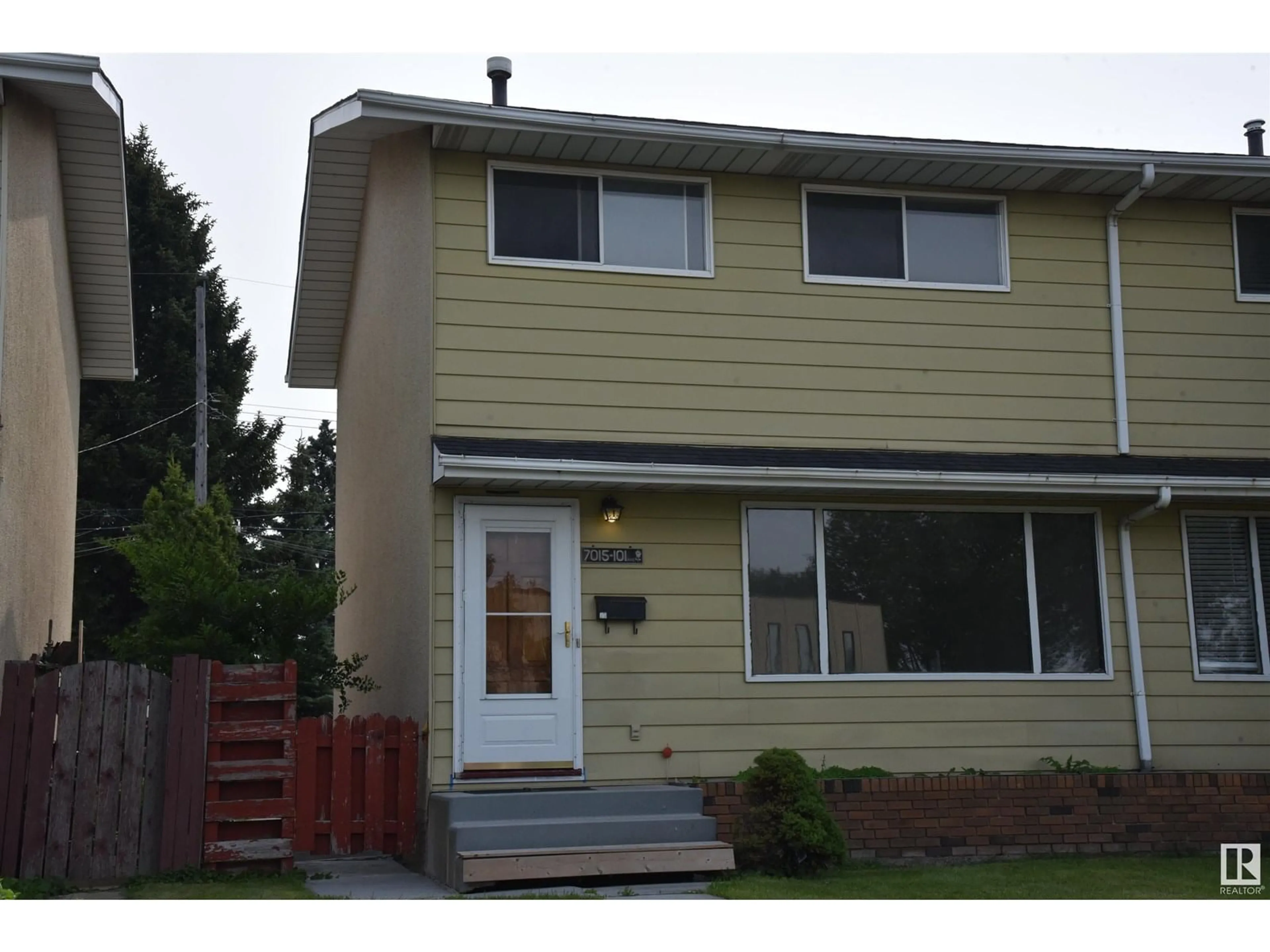 Home with vinyl exterior material, street for 7015 101 AV, Edmonton Alberta T6A0H6
