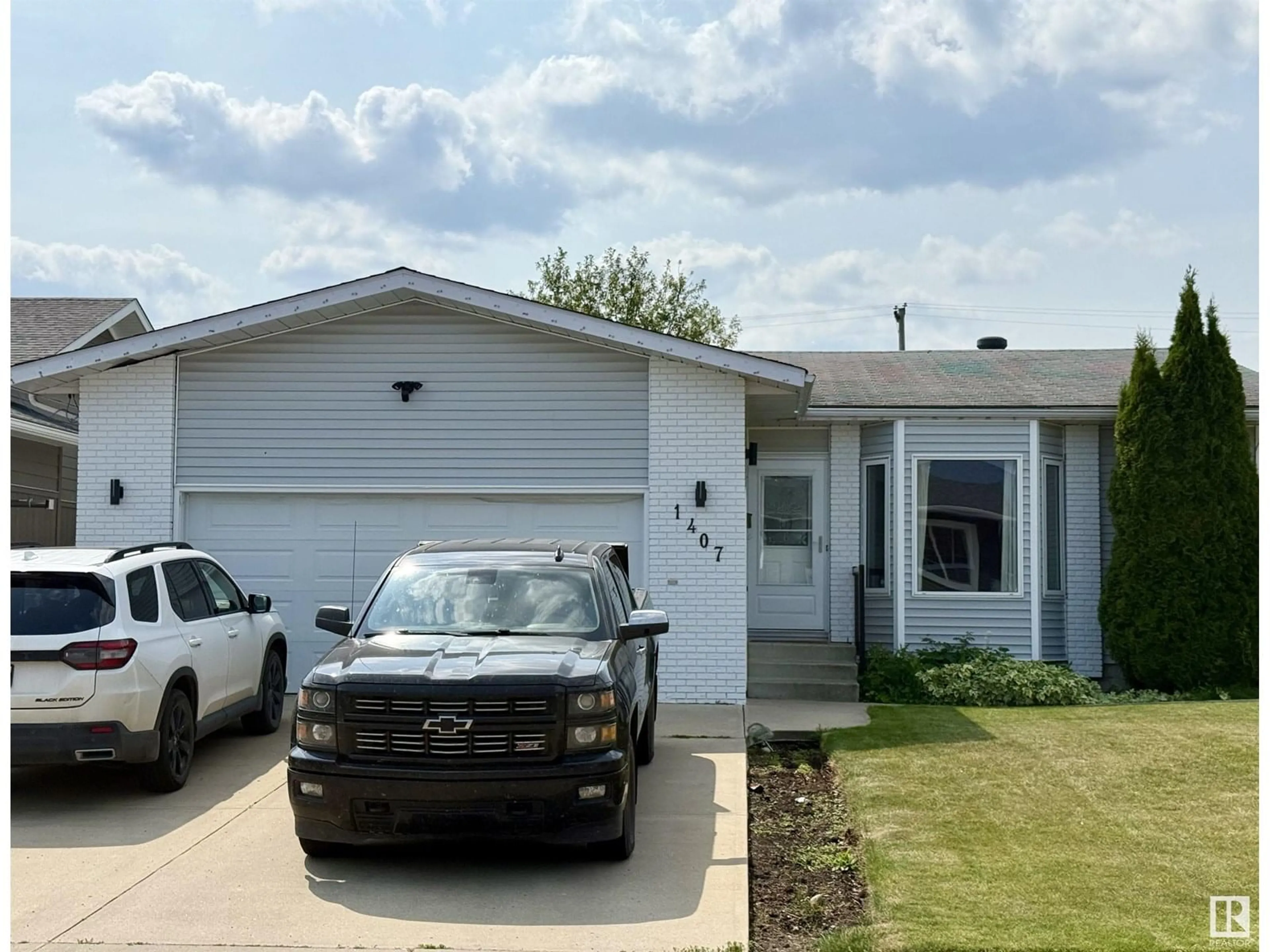 Home with vinyl exterior material, street for 1407 7 AV, Cold Lake Alberta T9M1B4