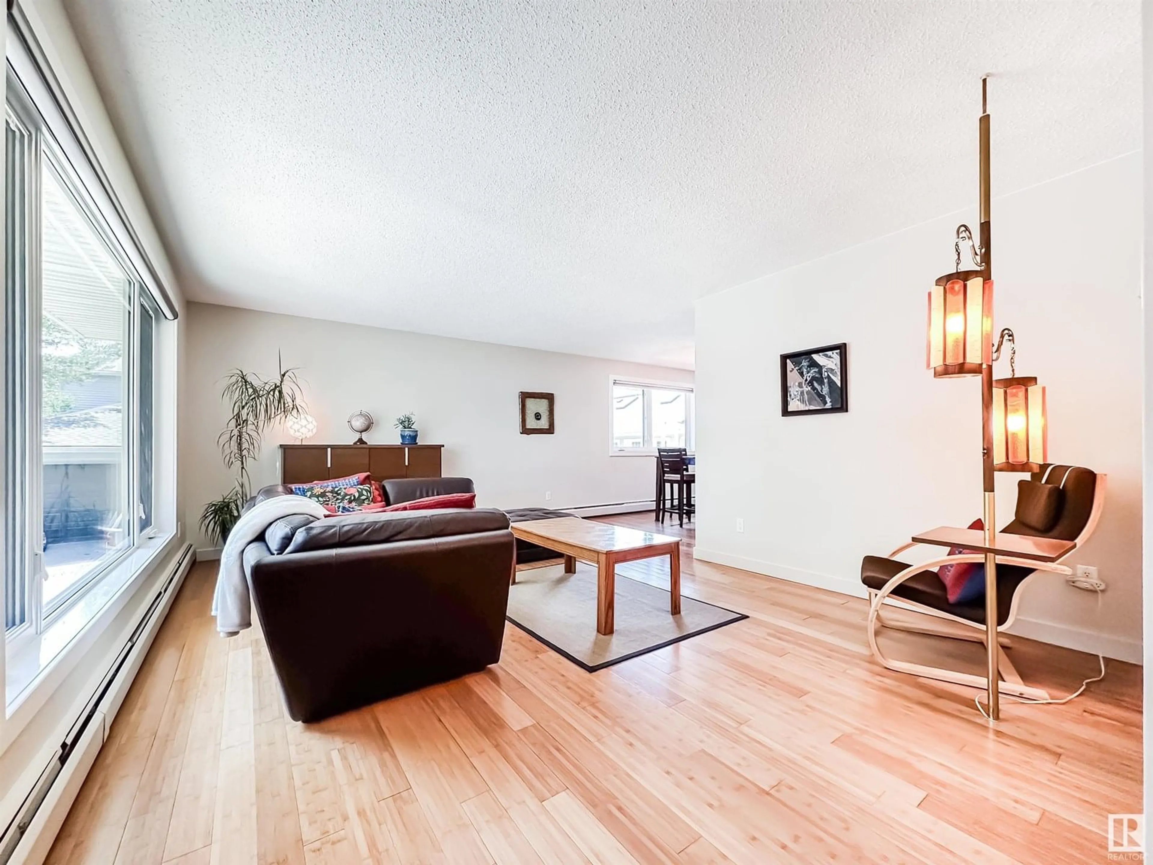 Living room with furniture, wood/laminate floor for NW - 11116 69 ST, Edmonton Alberta T5B1R4