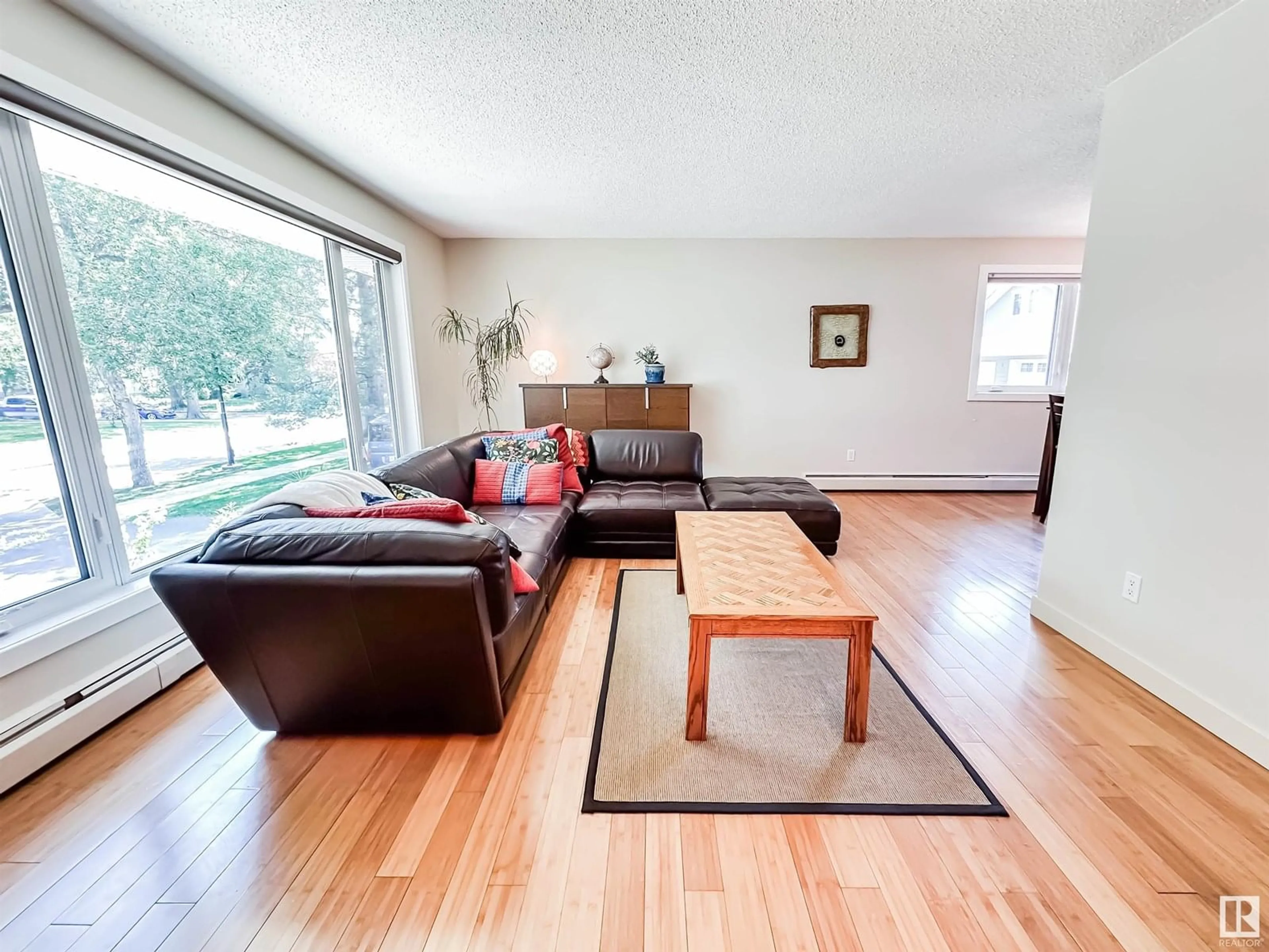 Living room with furniture, wood/laminate floor for NW - 11116 69 ST, Edmonton Alberta T5B1R4