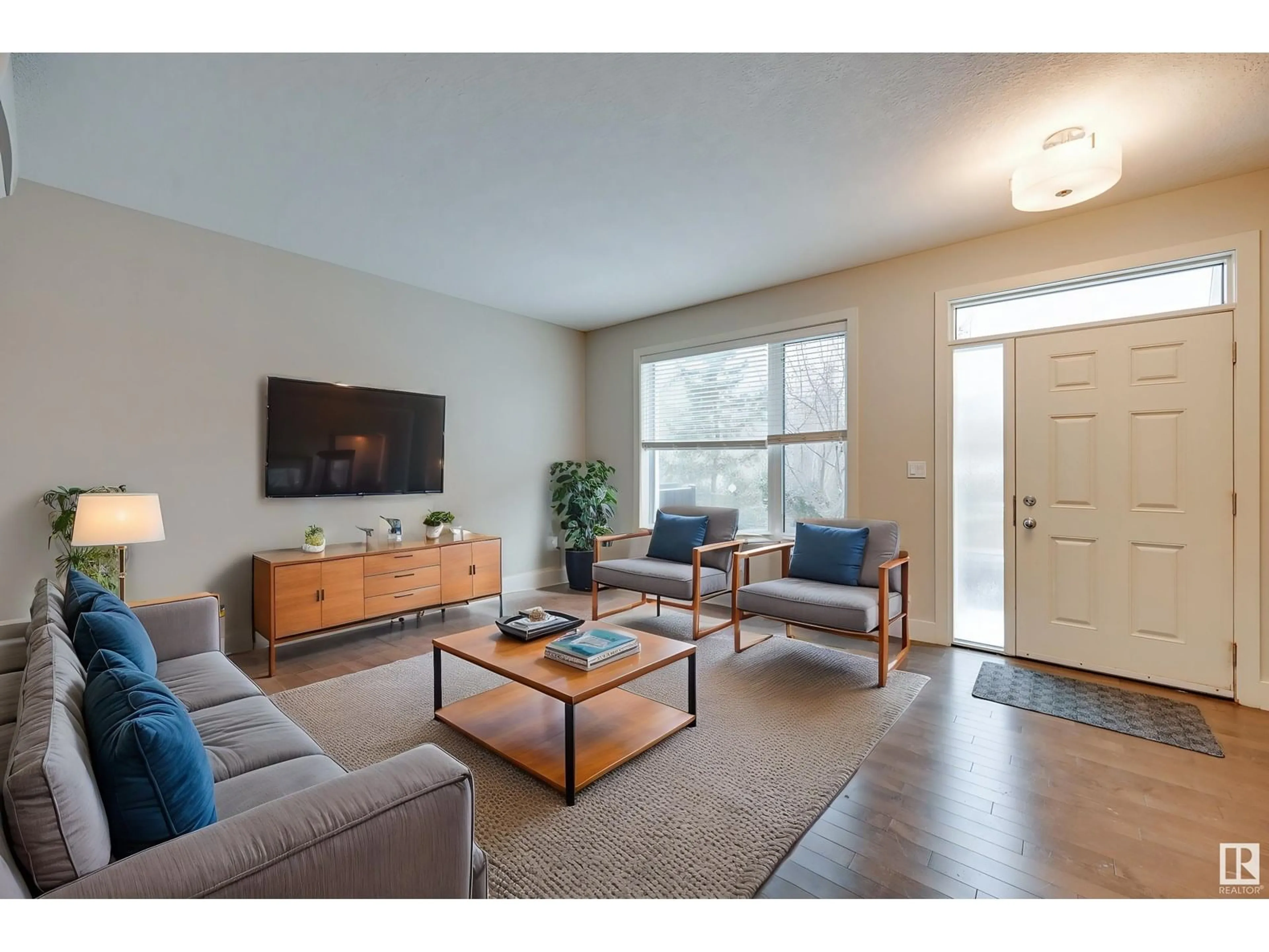 Living room with furniture, wood/laminate floor for NW - 7506 MAY CM, Edmonton Alberta T6R0G9