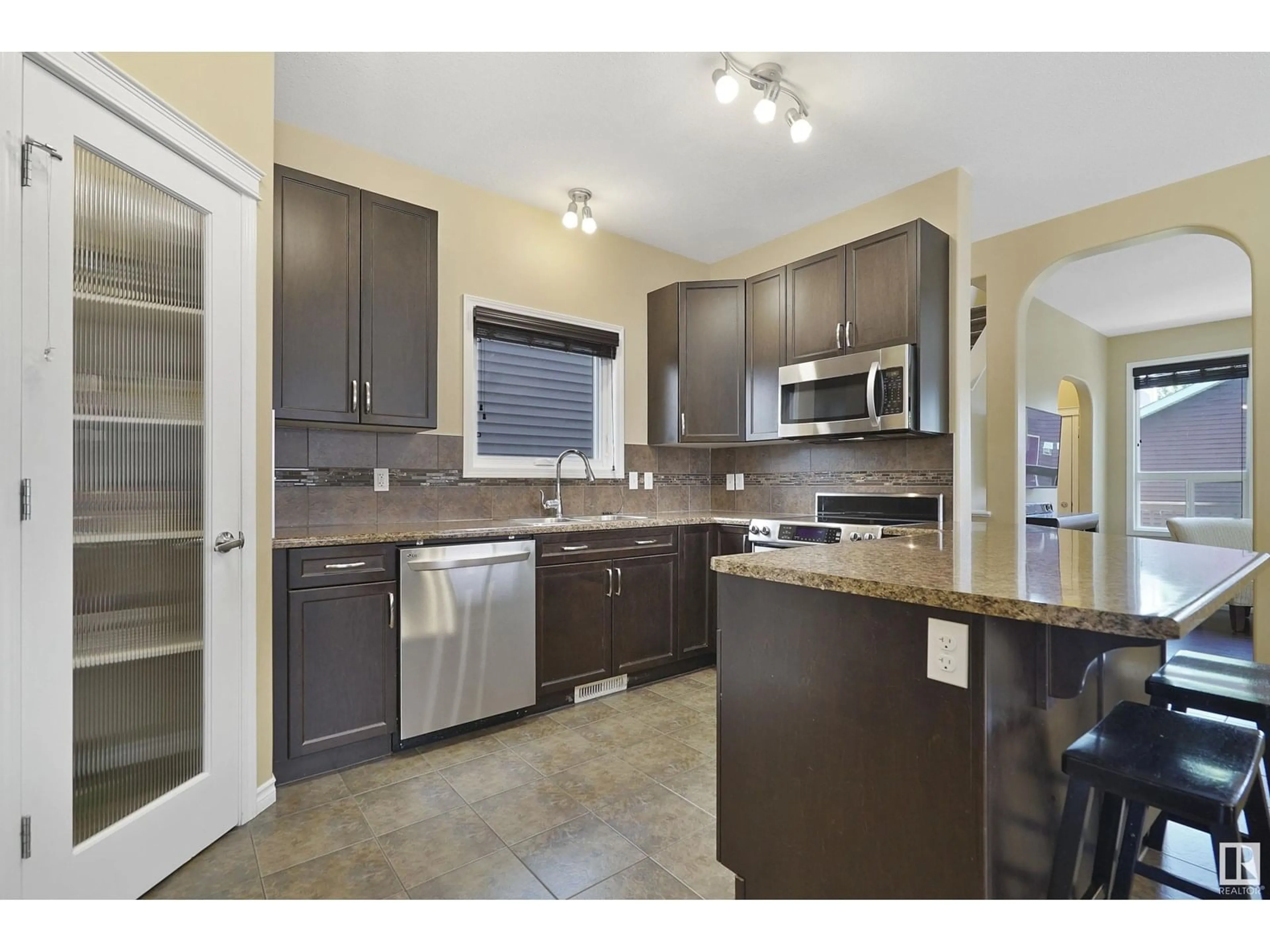 Open concept kitchen, ceramic/tile floor for 2035 74 ST, Edmonton Alberta T6X0V7
