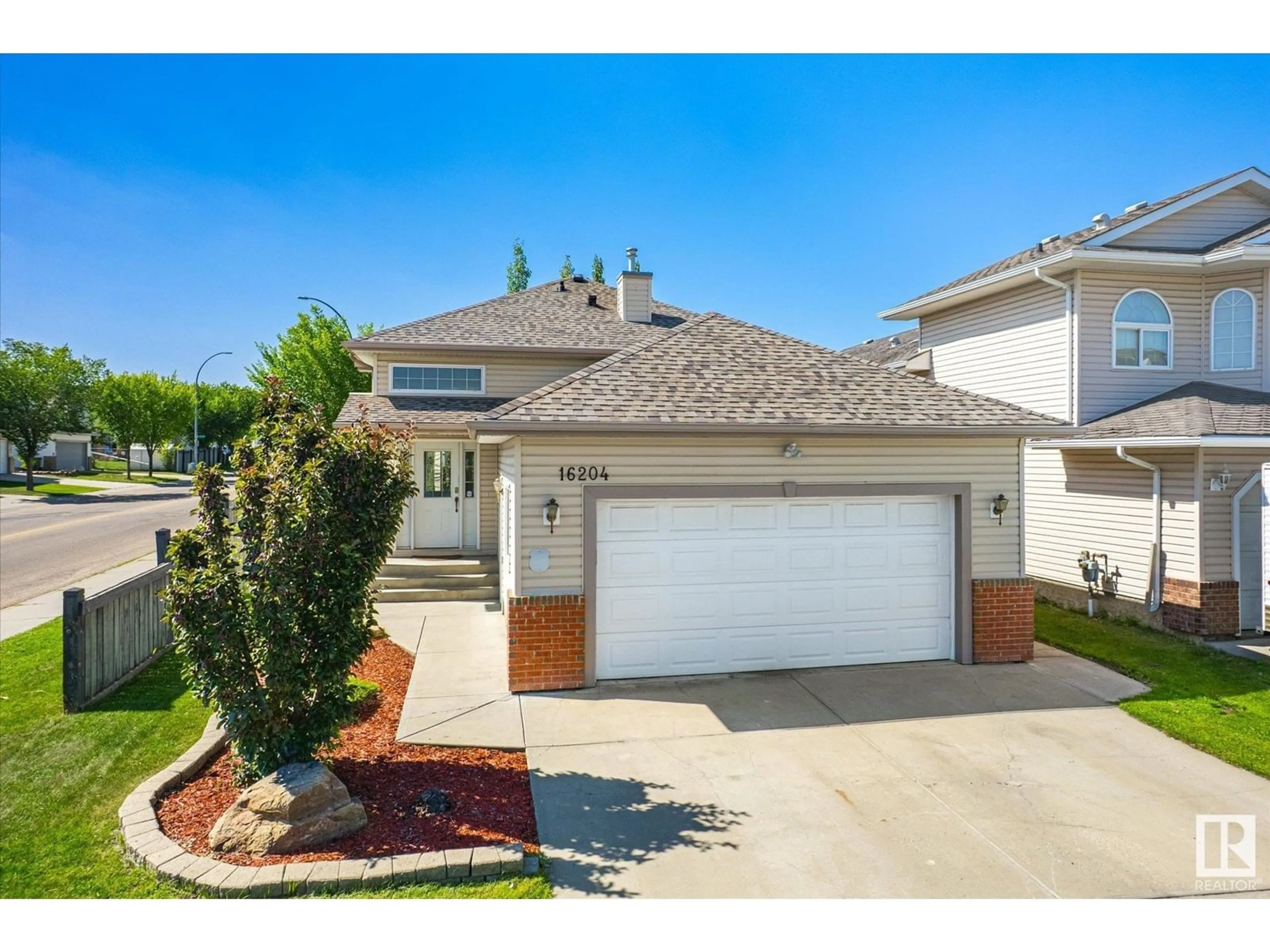 Home with vinyl exterior material, street for 16204 51 ST, Edmonton Alberta T5Y3K2