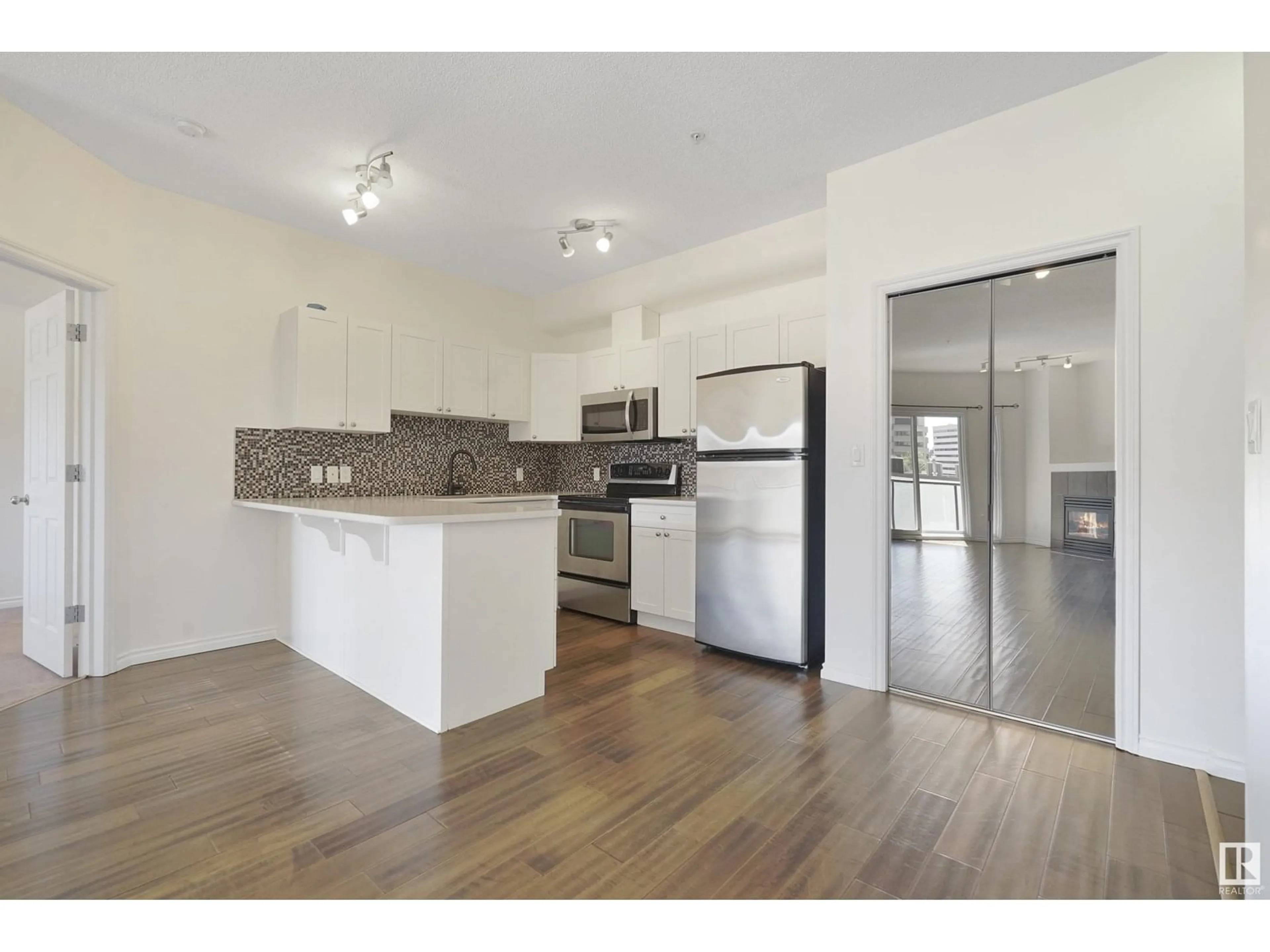 Open concept kitchen, wood/laminate floor for #414 - 10235 112 ST, Edmonton Alberta T5K1M7