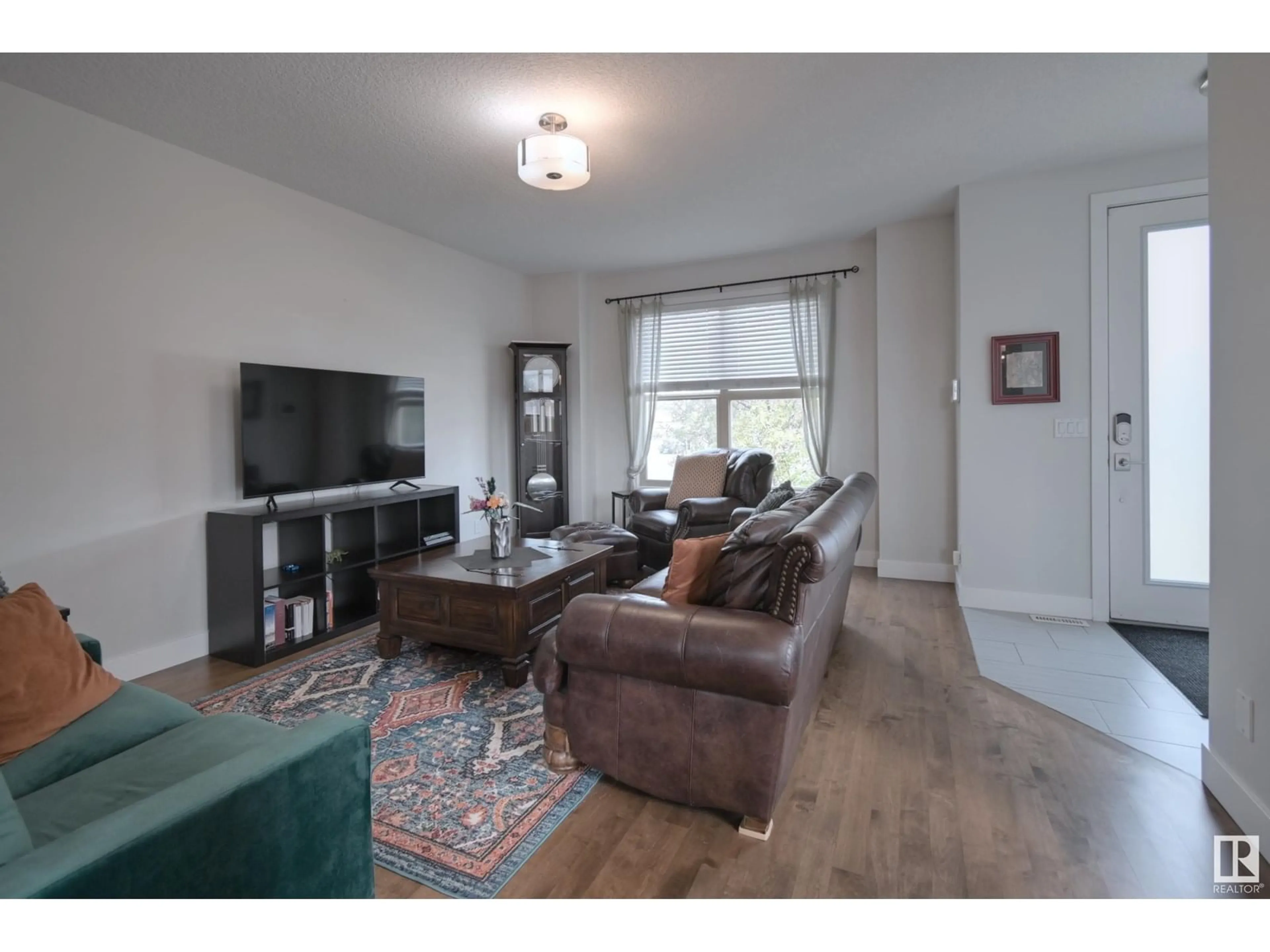 Living room with furniture, wood/laminate floor for 90 GREENBURY BV, Spruce Grove Alberta T7X0A7