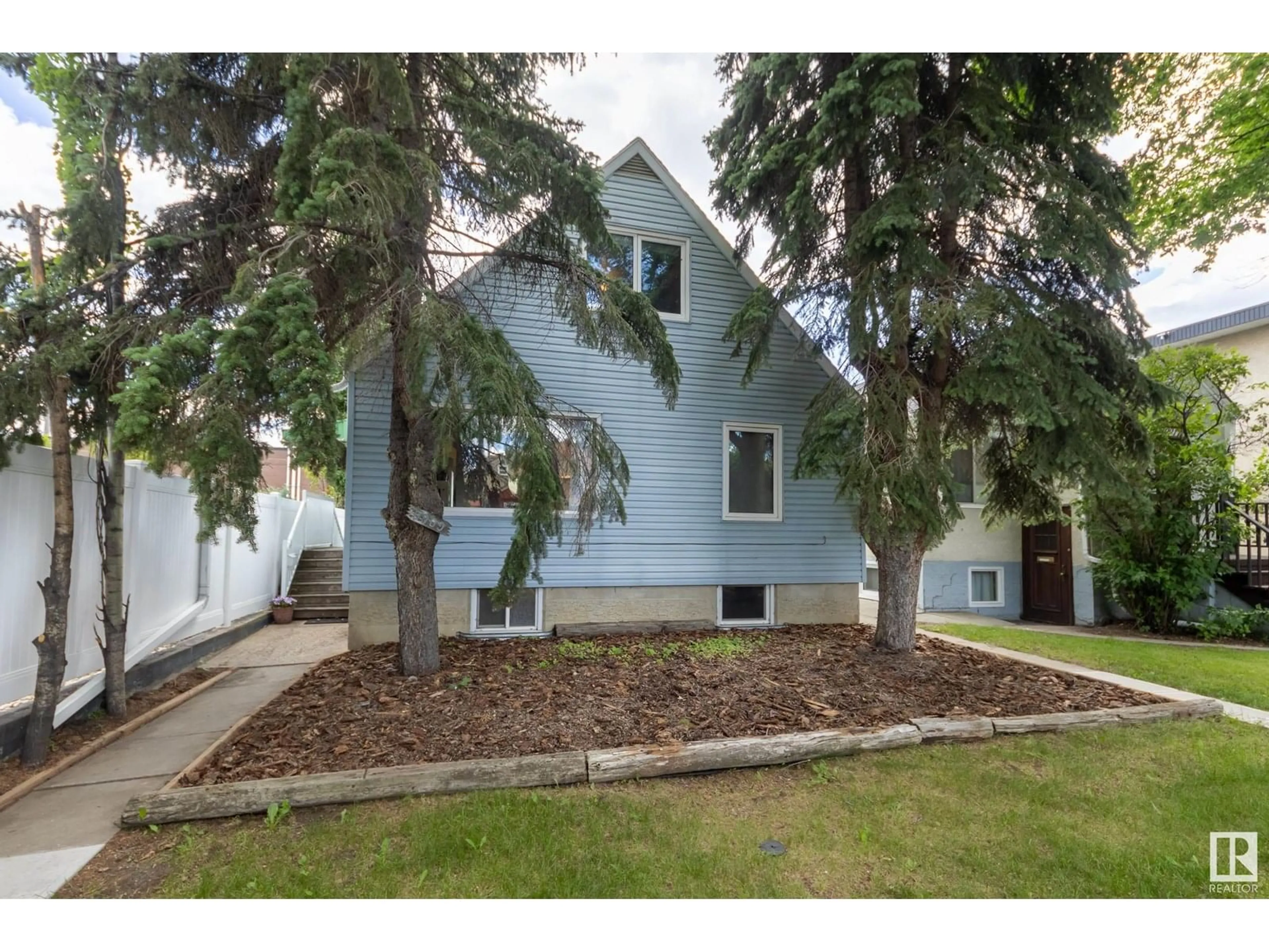 Home with vinyl exterior material, street for 9909 87 AV, Edmonton Alberta T6E2N8