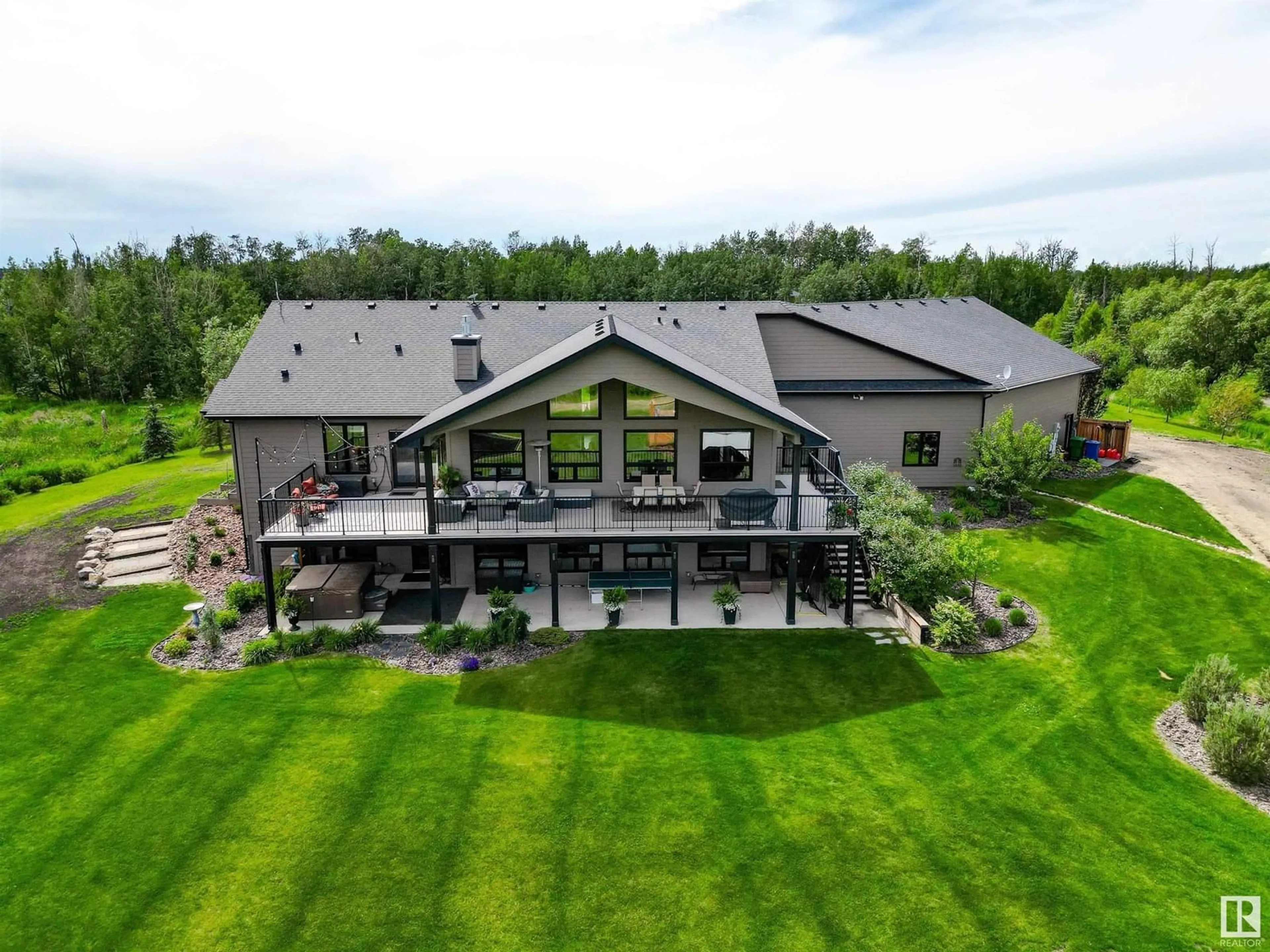 A pic from outside/outdoor area/front of a property/back of a property/a pic from drone, mountain view for 90 23449 TWP ROAD 505, Rural Leduc County Alberta T4X0S1