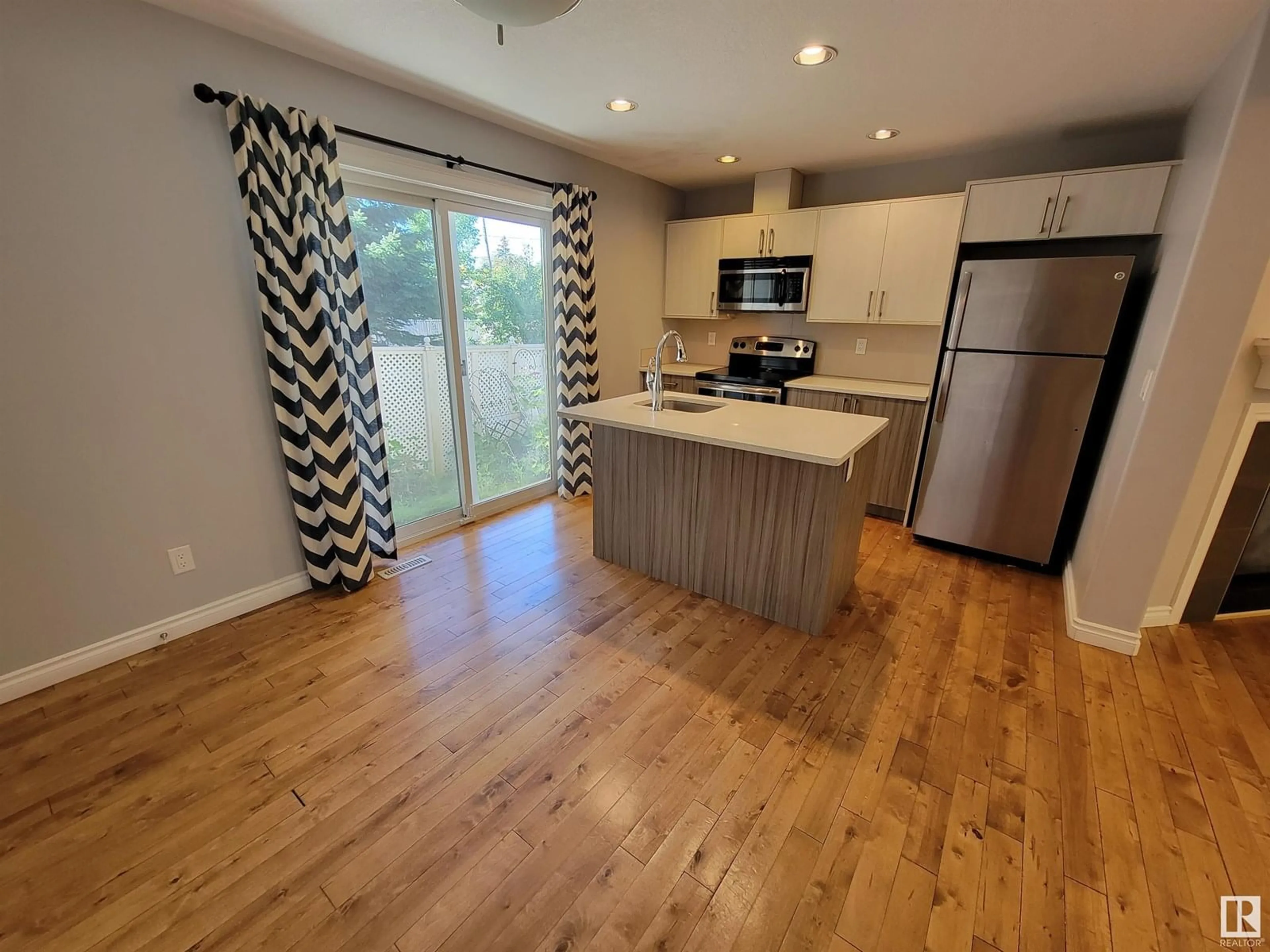 Open concept kitchen, wood/laminate floor for #1-4 - 8514 83 AV, Edmonton Alberta T6C1B1