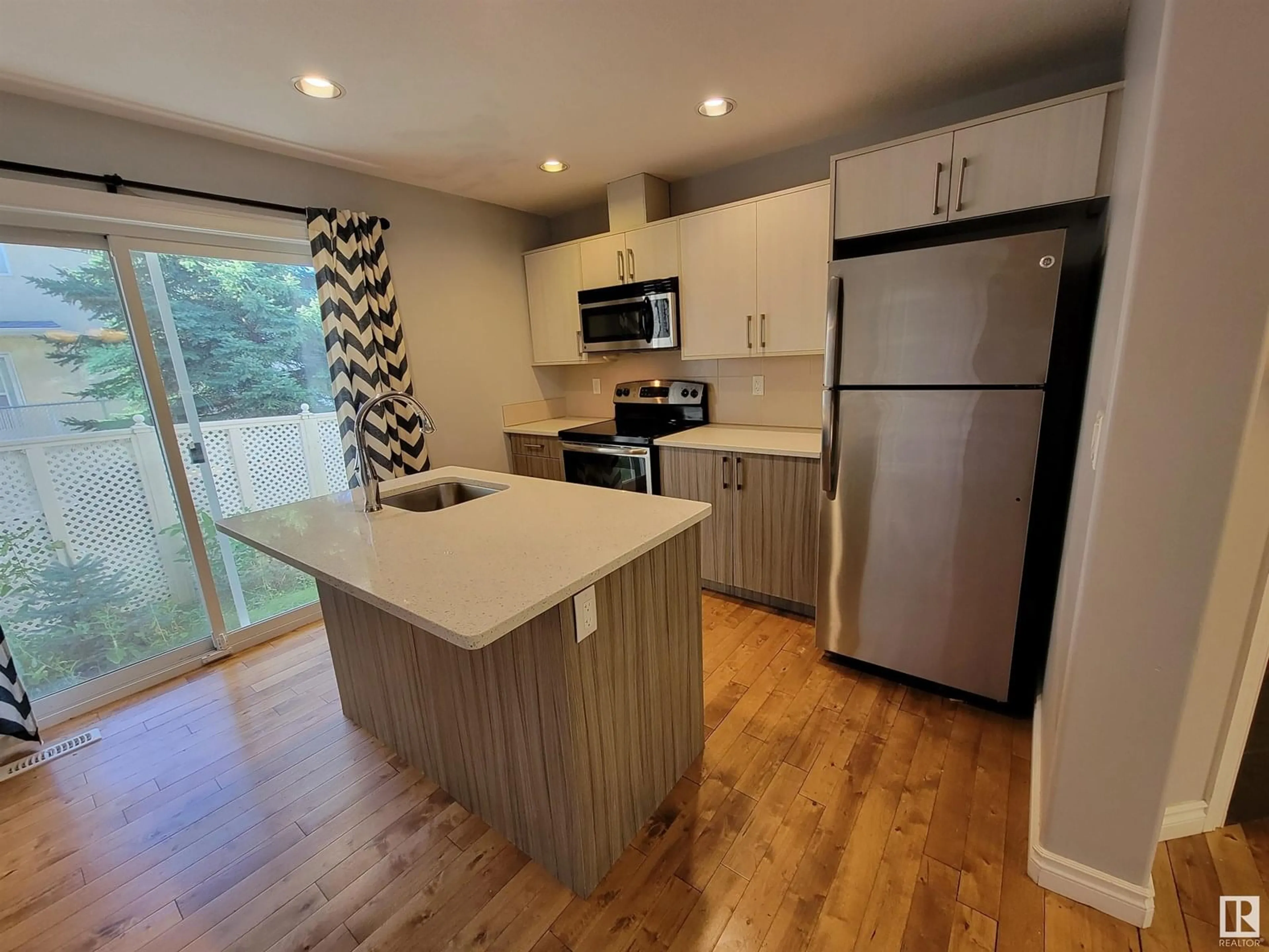 Open concept kitchen, wood/laminate floor for #1-4 - 8514 83 AV, Edmonton Alberta T6C1B1