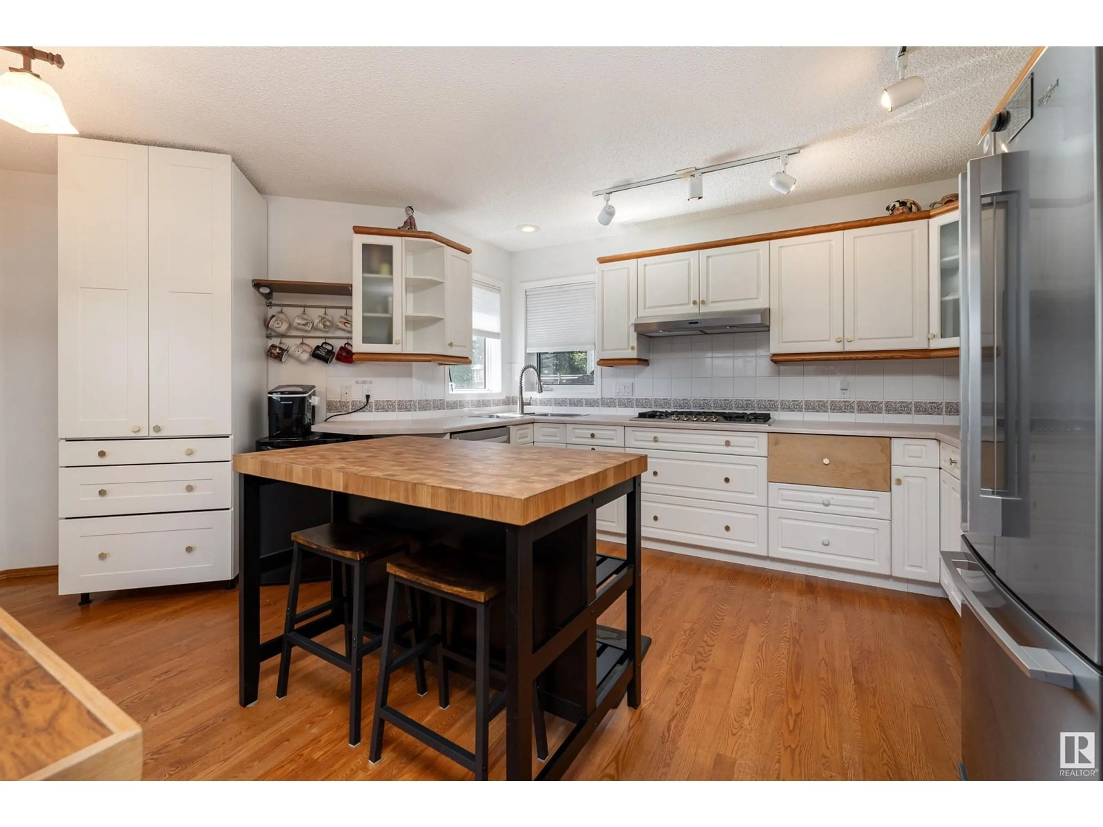 Open concept kitchen, wood/laminate floor for 11805 10A AV, Edmonton Alberta T6J7A7