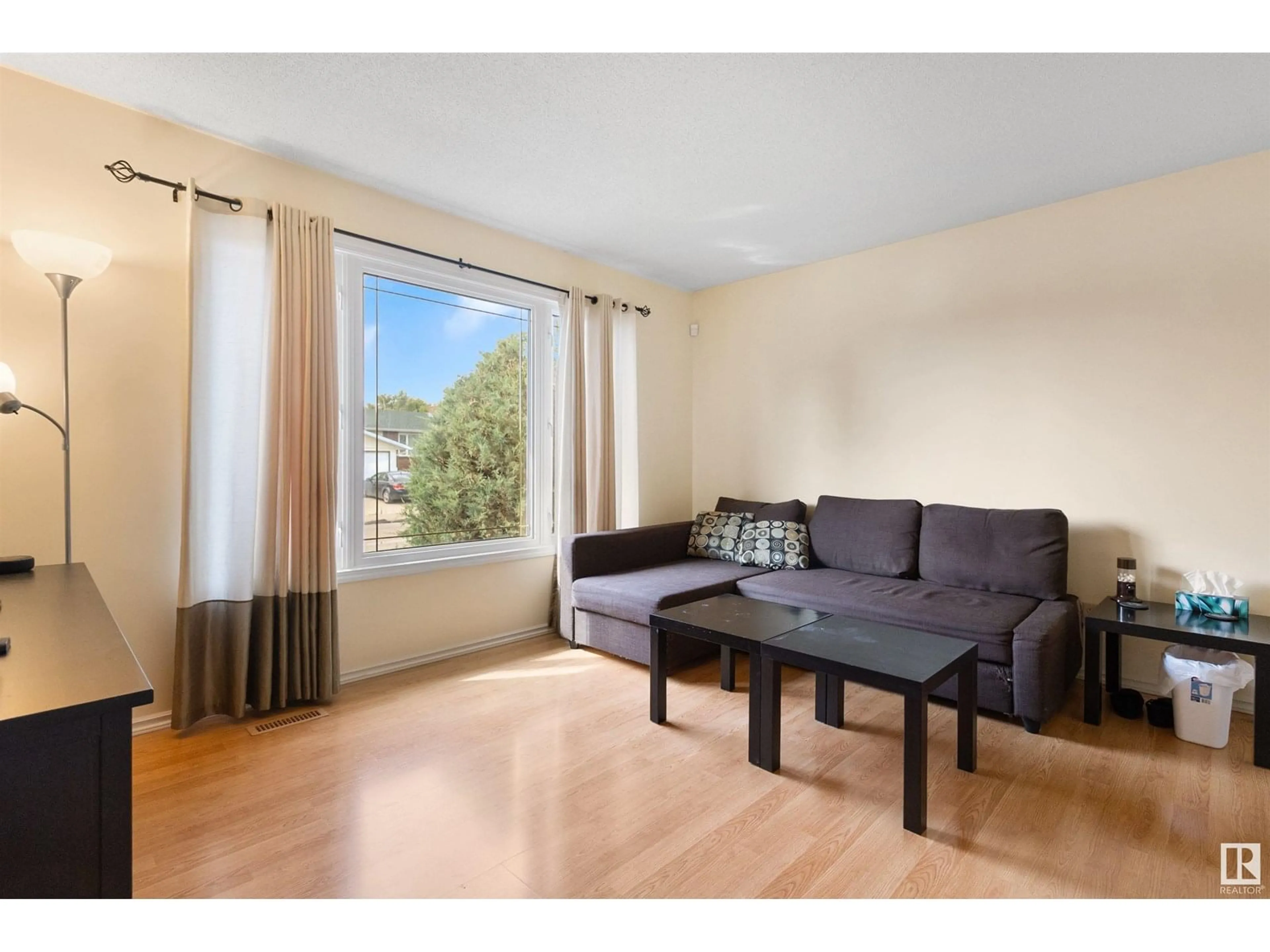 Living room with furniture, wood/laminate floor for 2610 129A AV, Edmonton Alberta T5A3Y1