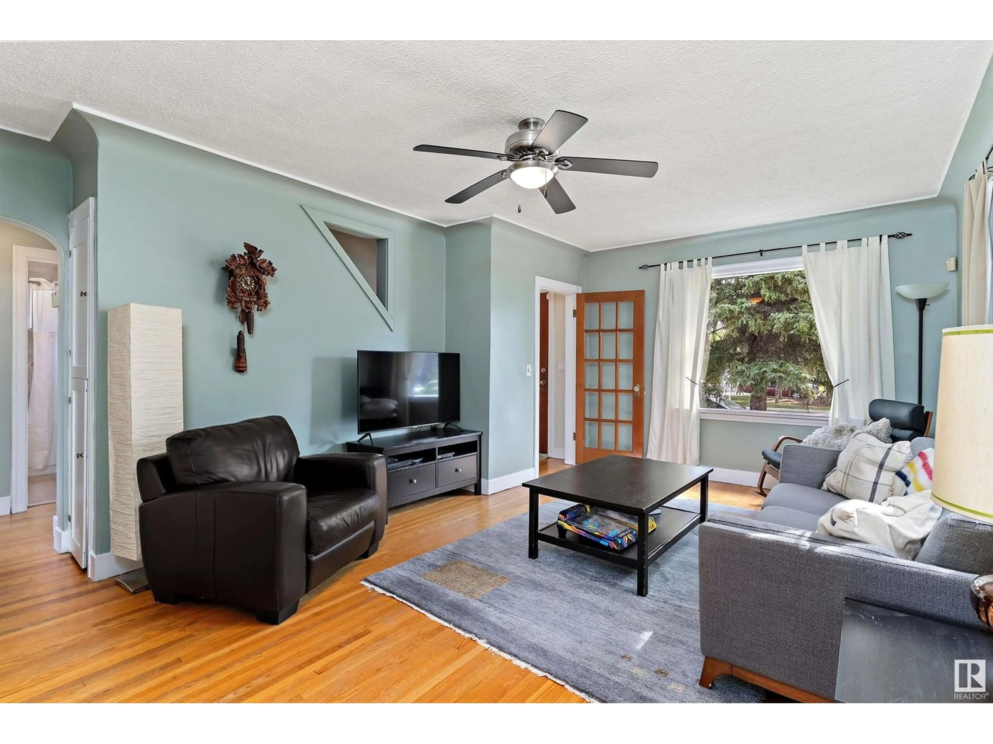 Living room with furniture, wood/laminate floor for 11042 76 ST, Edmonton Alberta T5B2C6
