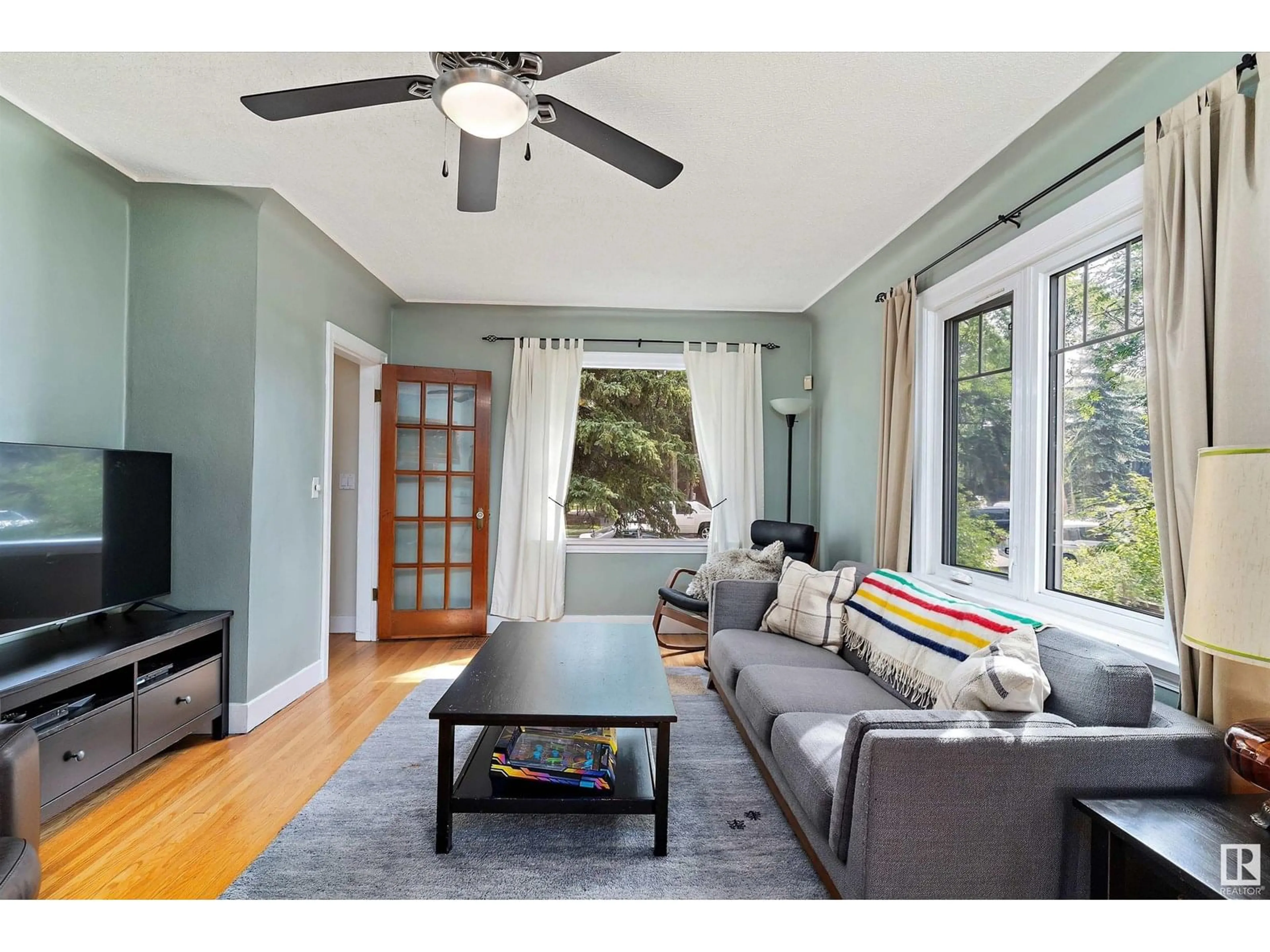 Living room with furniture, wood/laminate floor for 11042 76 ST, Edmonton Alberta T5B2C6