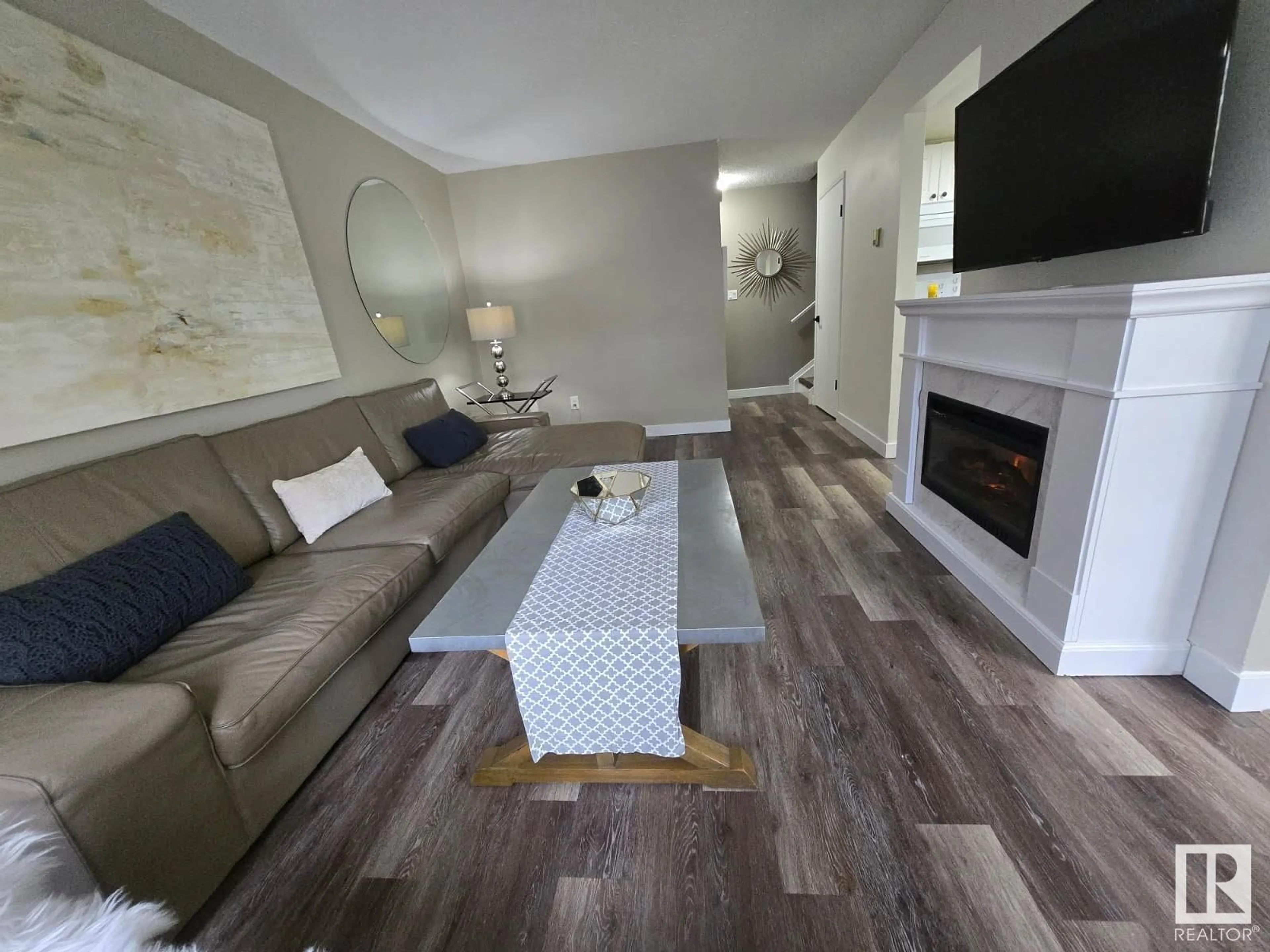 Living room with furniture, wood/laminate floor for 9 - 18305 89 AV NW, Edmonton Alberta T6T1X2