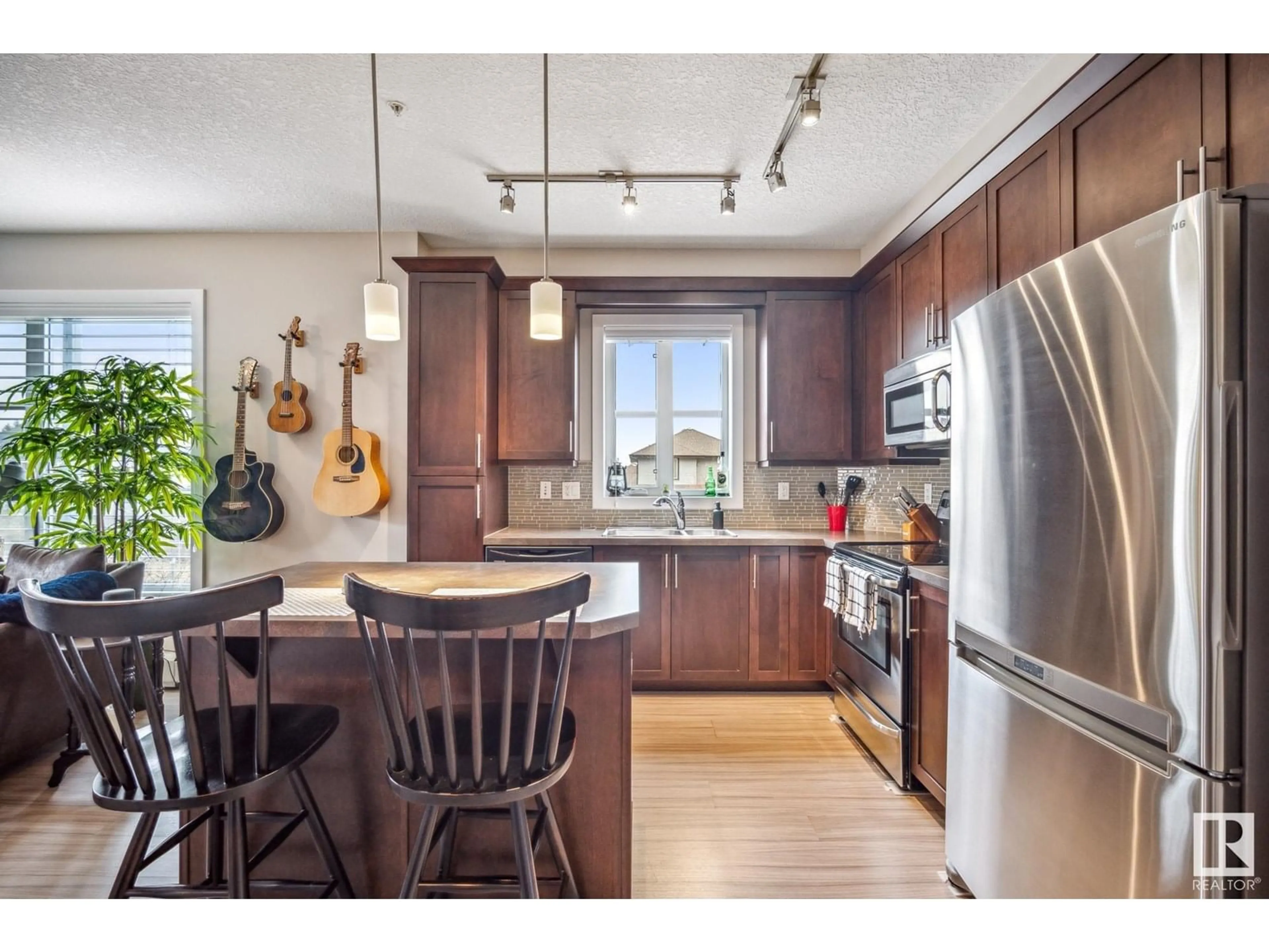 Open concept kitchen, wood/laminate floor for #204 - 2588 ANDERSON WY, Edmonton Alberta T6W0R2