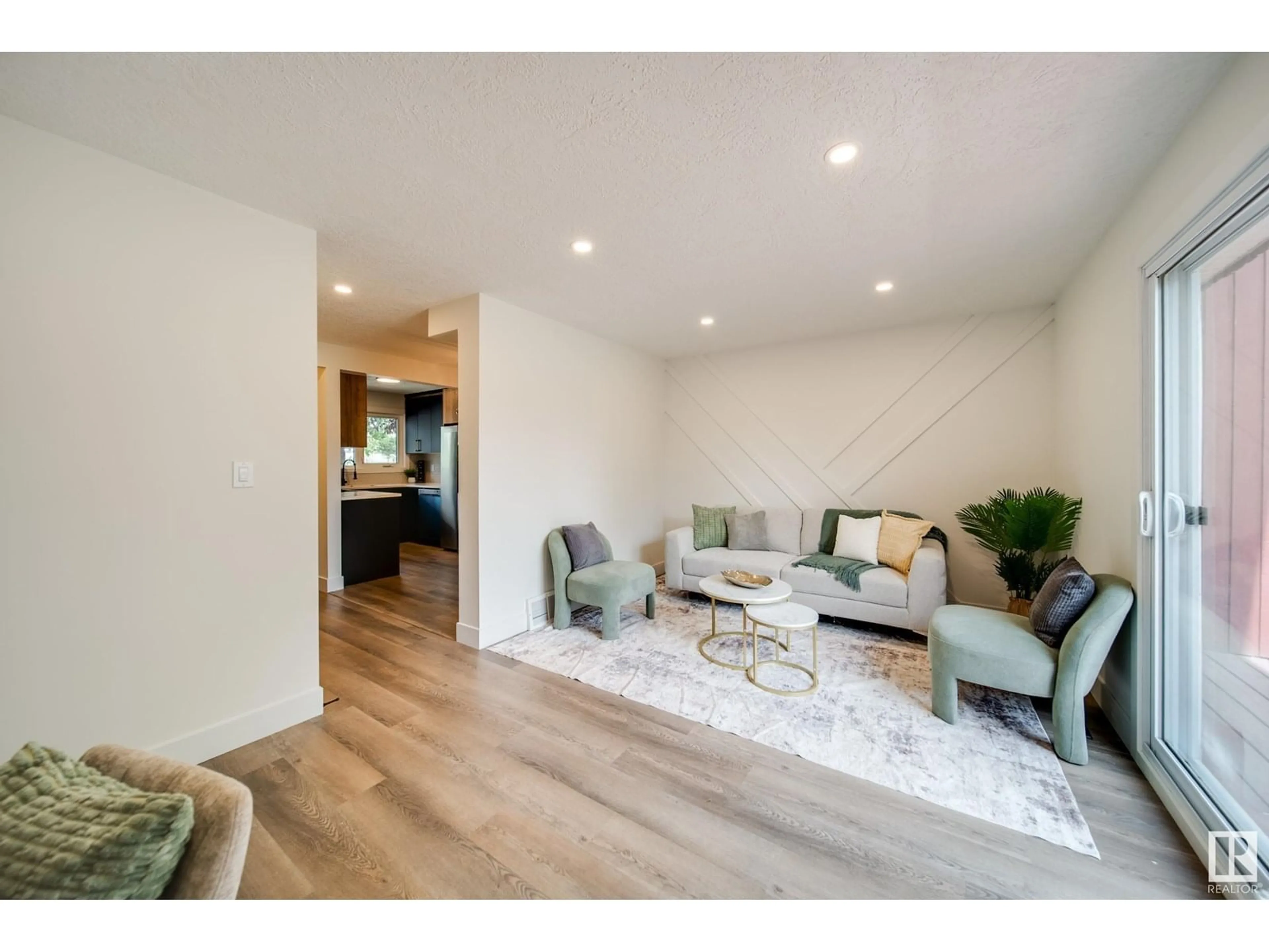 Living room with furniture, wood/laminate floor for 10630 BEAUMARIS RD, Edmonton Alberta T5X3N4