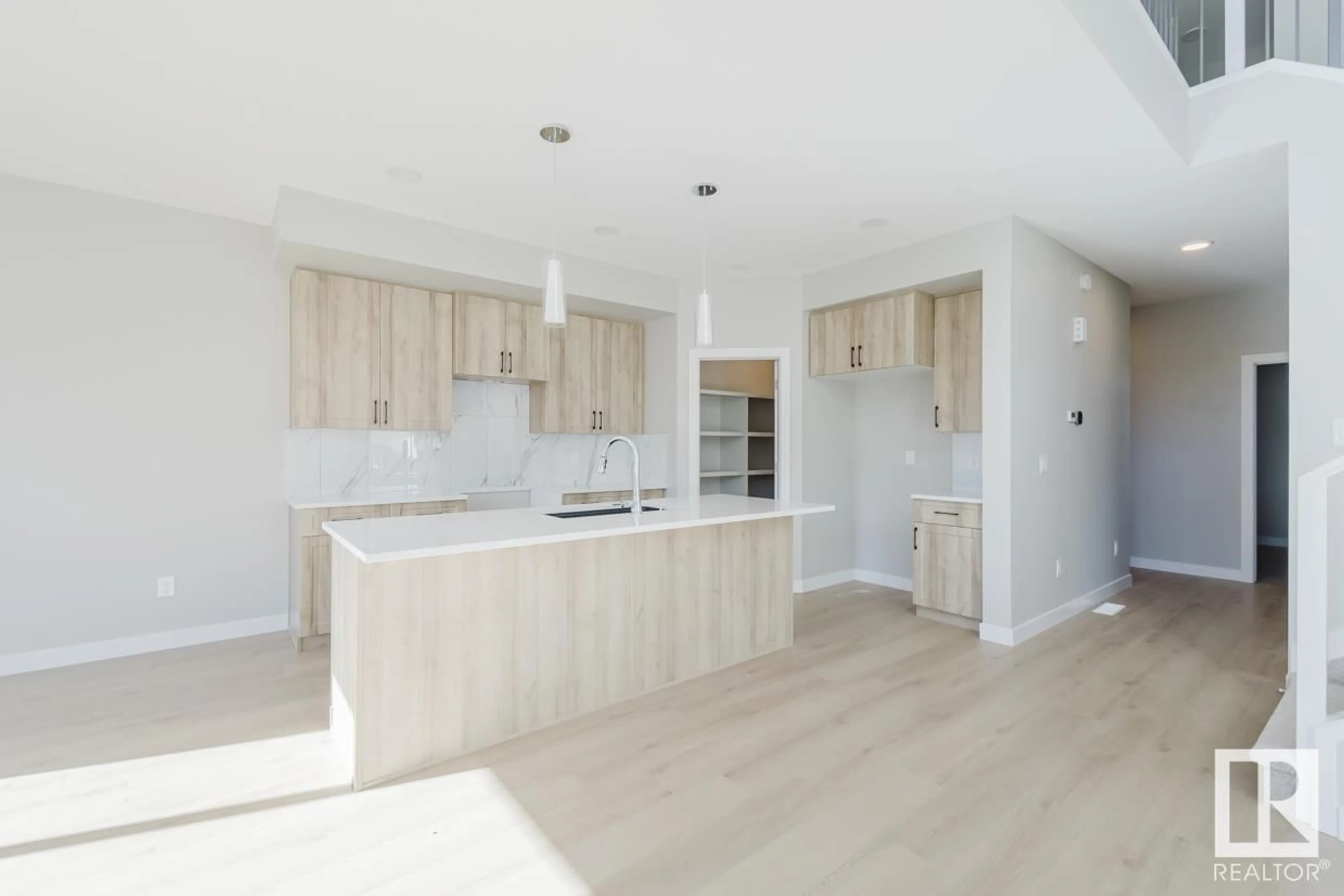 Open concept kitchen, wood/laminate floor for 5103 69 ST, Beaumont Alberta T4X3E4