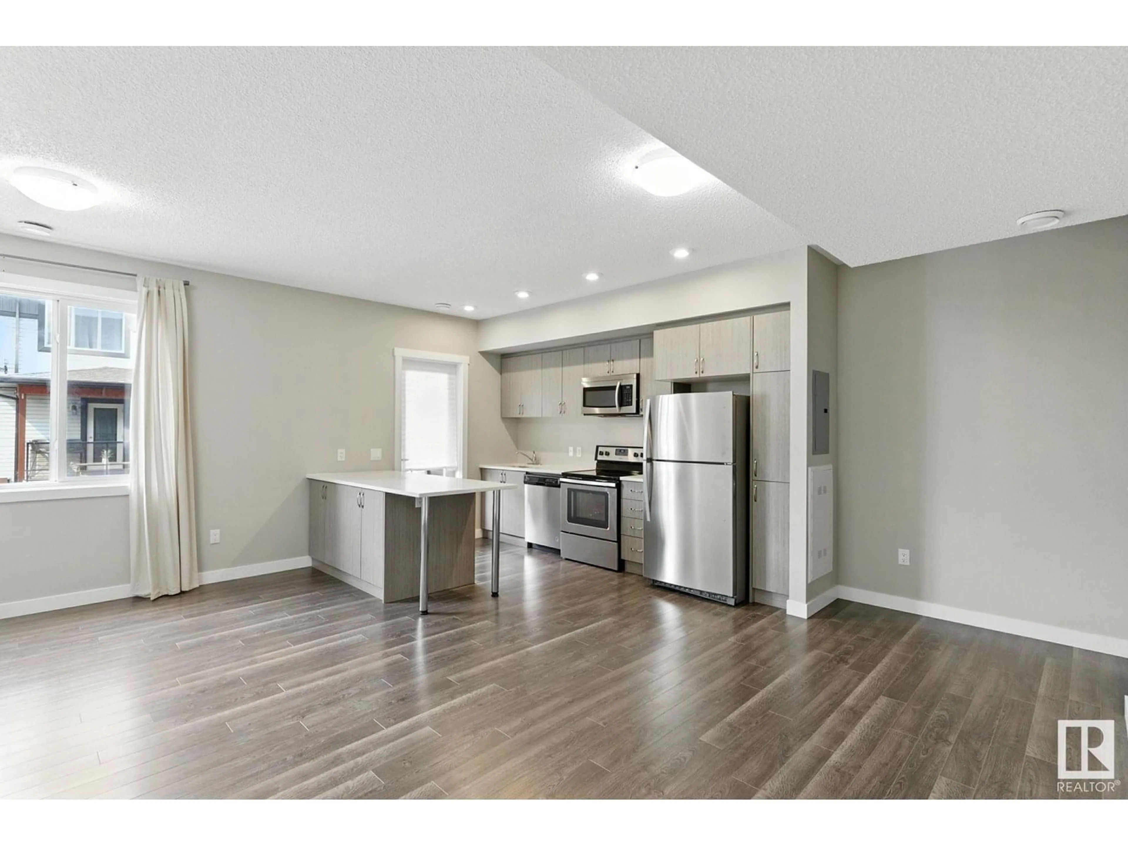 Open concept kitchen, wood/laminate floor for 446 - 53 ALLARD BV, Edmonton Alberta T6W3S7