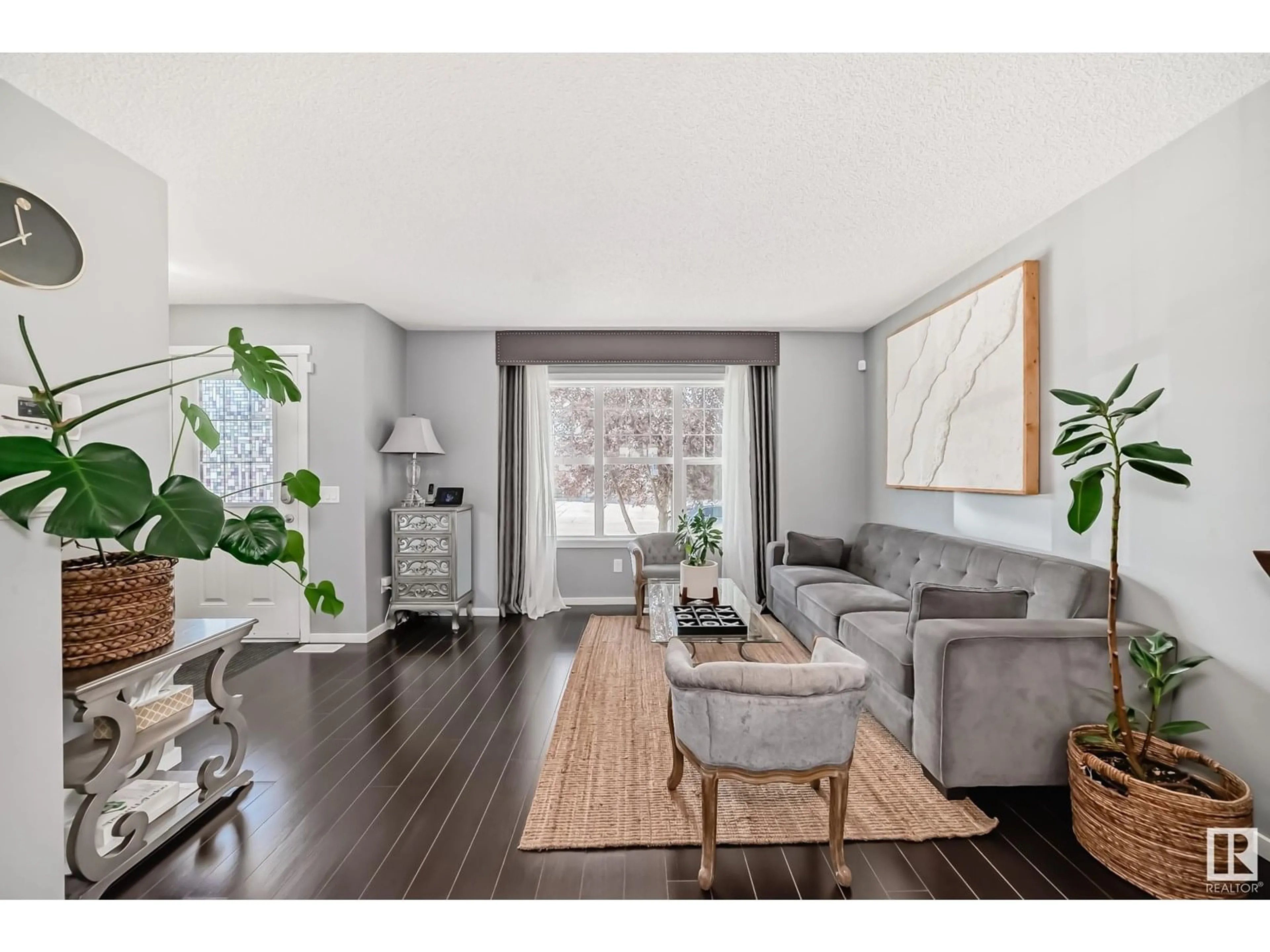 Living room with furniture, wood/laminate floor for 2838 18A AV, Edmonton Alberta T6T0N8