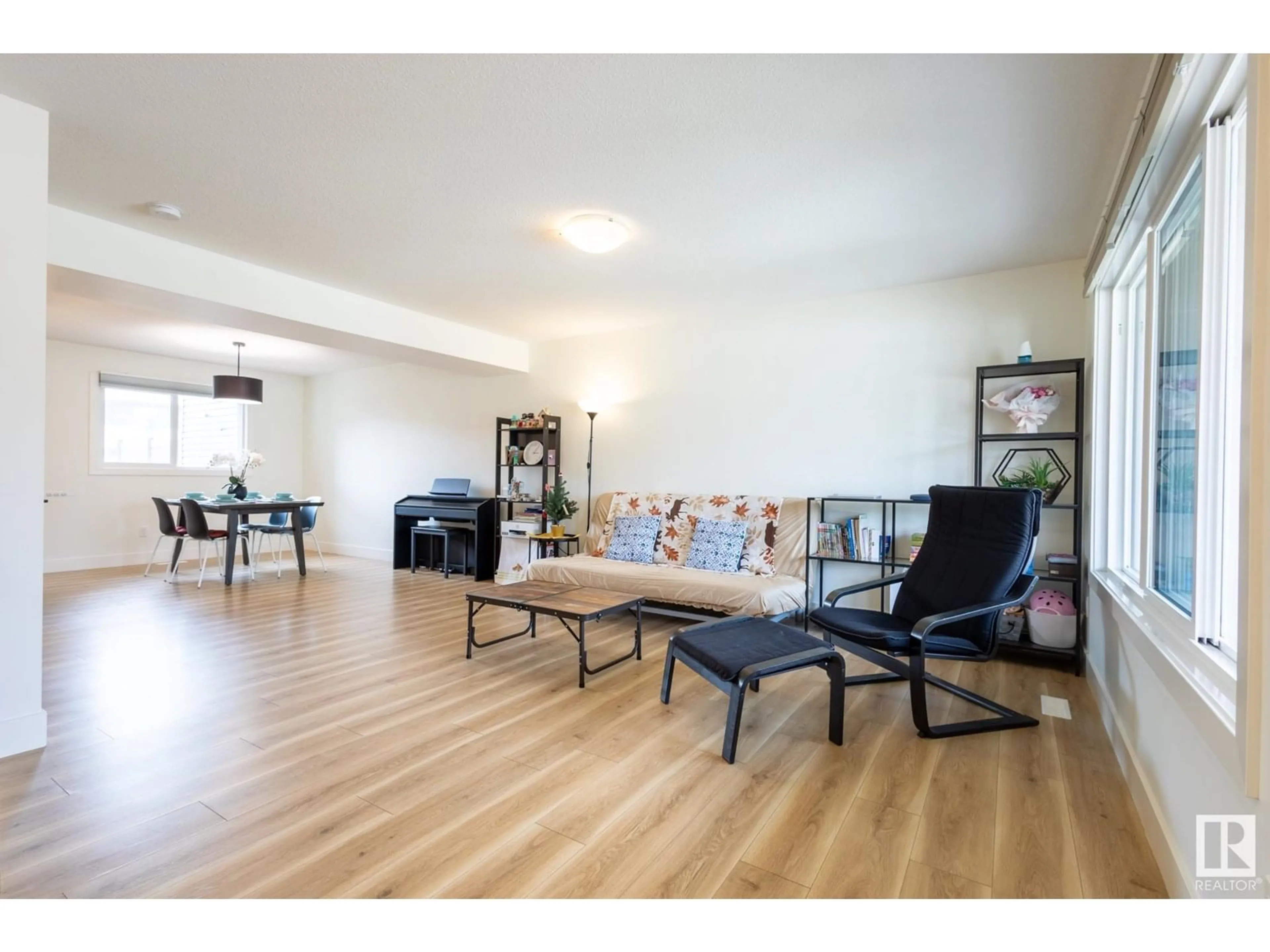Living room with furniture, wood/laminate floor for 6481 KING WD, Edmonton Alberta T6W3Z9