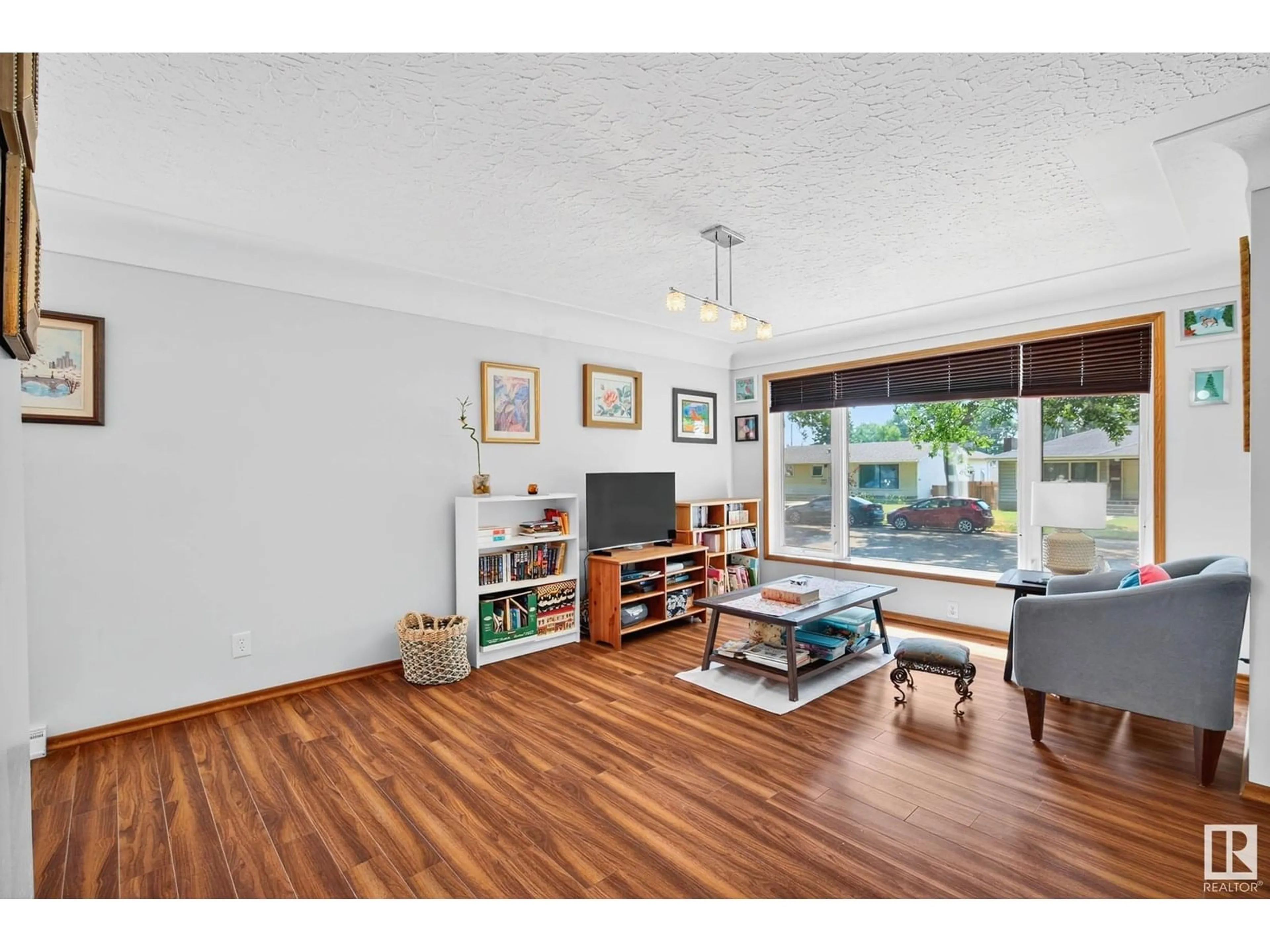 Living room with furniture, wood/laminate floor for 4816 117 AV, Edmonton Alberta T5W0Z1