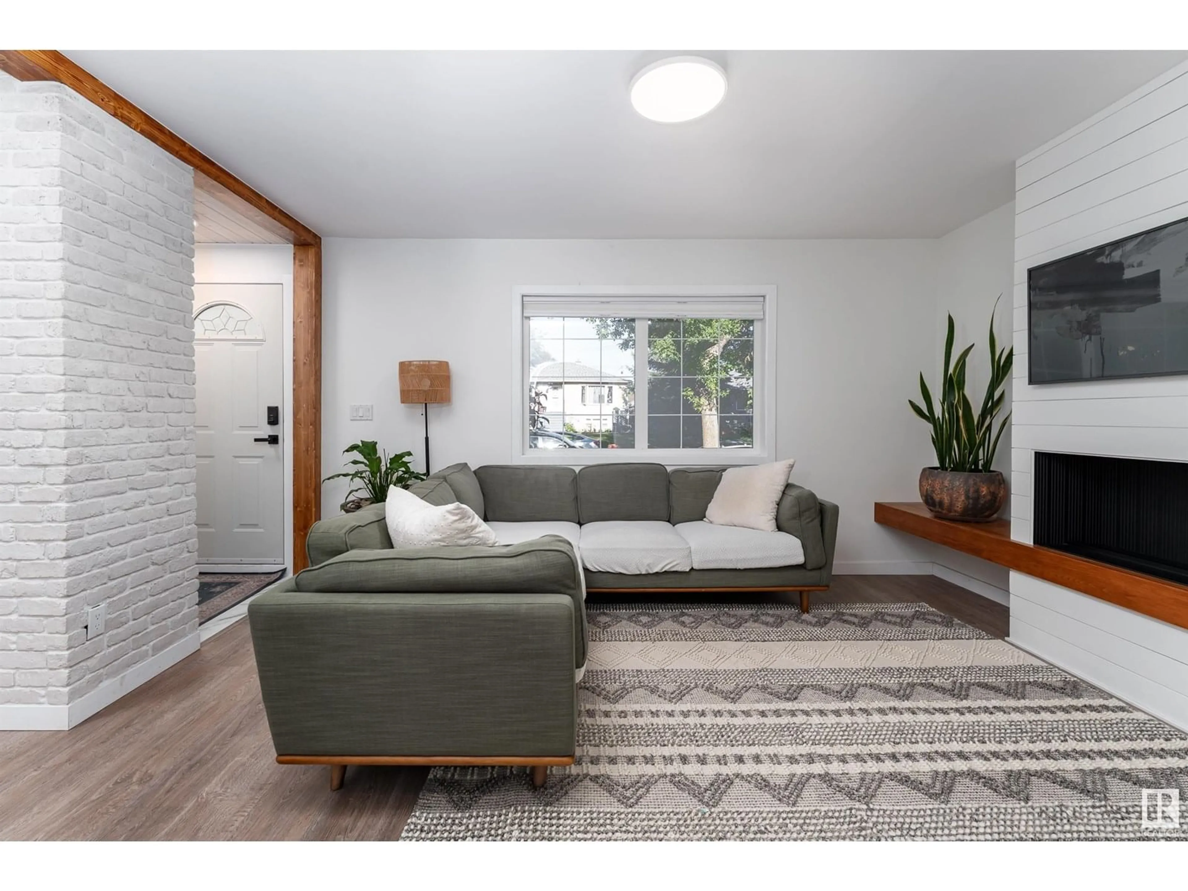 Living room with furniture, wood/laminate floor for NW - 10524 80 ST, Edmonton Alberta T6A3J7