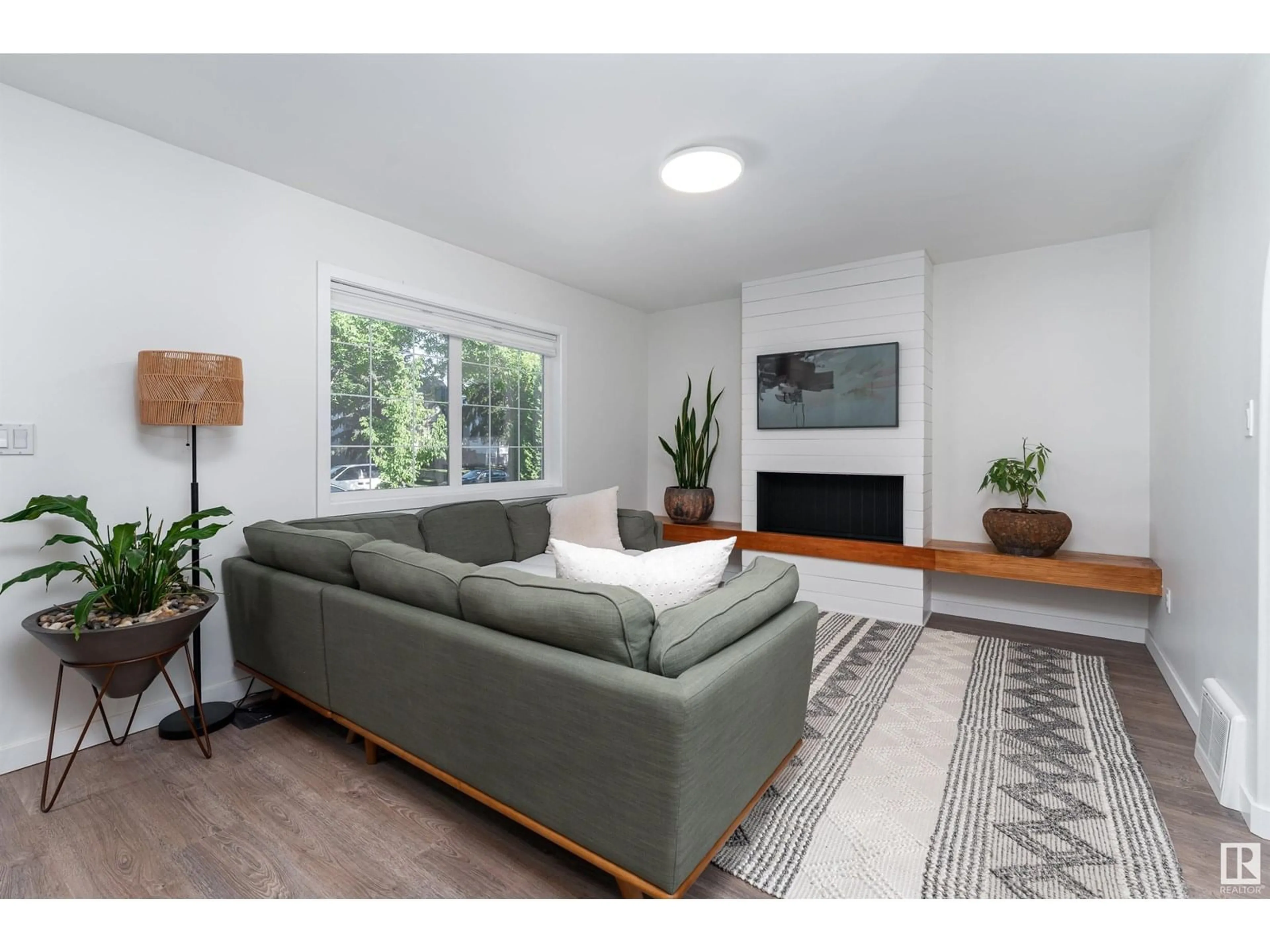 Living room with furniture, wood/laminate floor for NW - 10524 80 ST, Edmonton Alberta T6A3J7