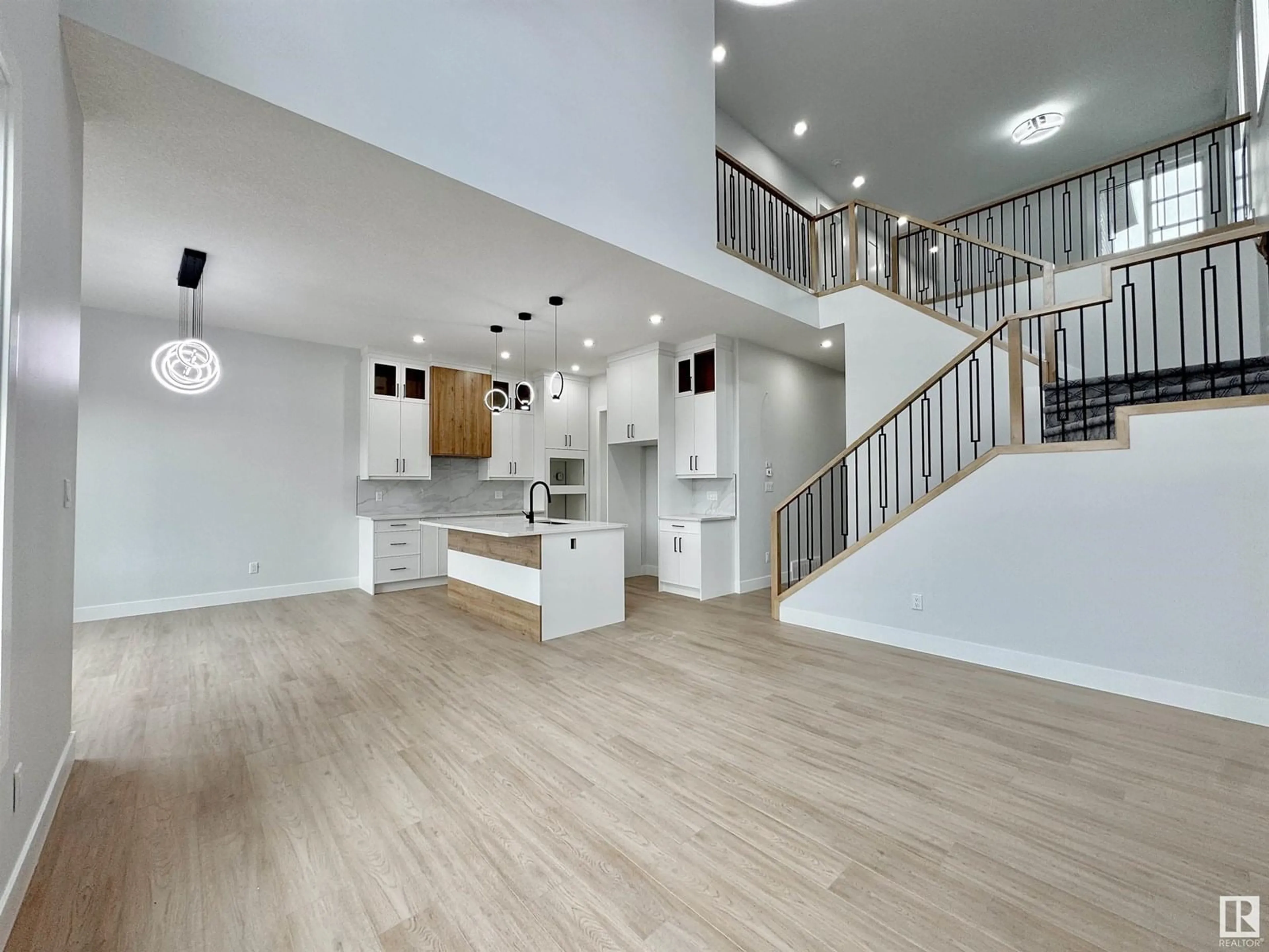 Open concept kitchen, wood/laminate floor for 7041 KIVIAQ CR, Edmonton Alberta T6W5R2