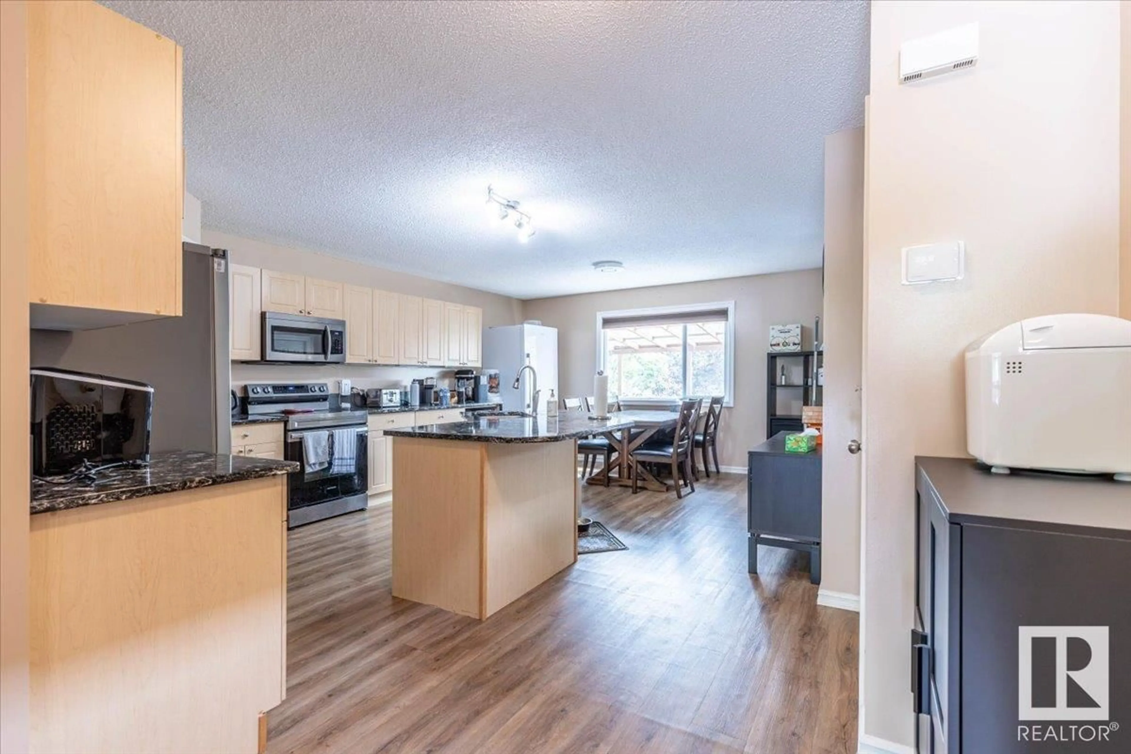 Open concept kitchen, wood/laminate floor for 21335 91A AV, Edmonton Alberta T5T0W5