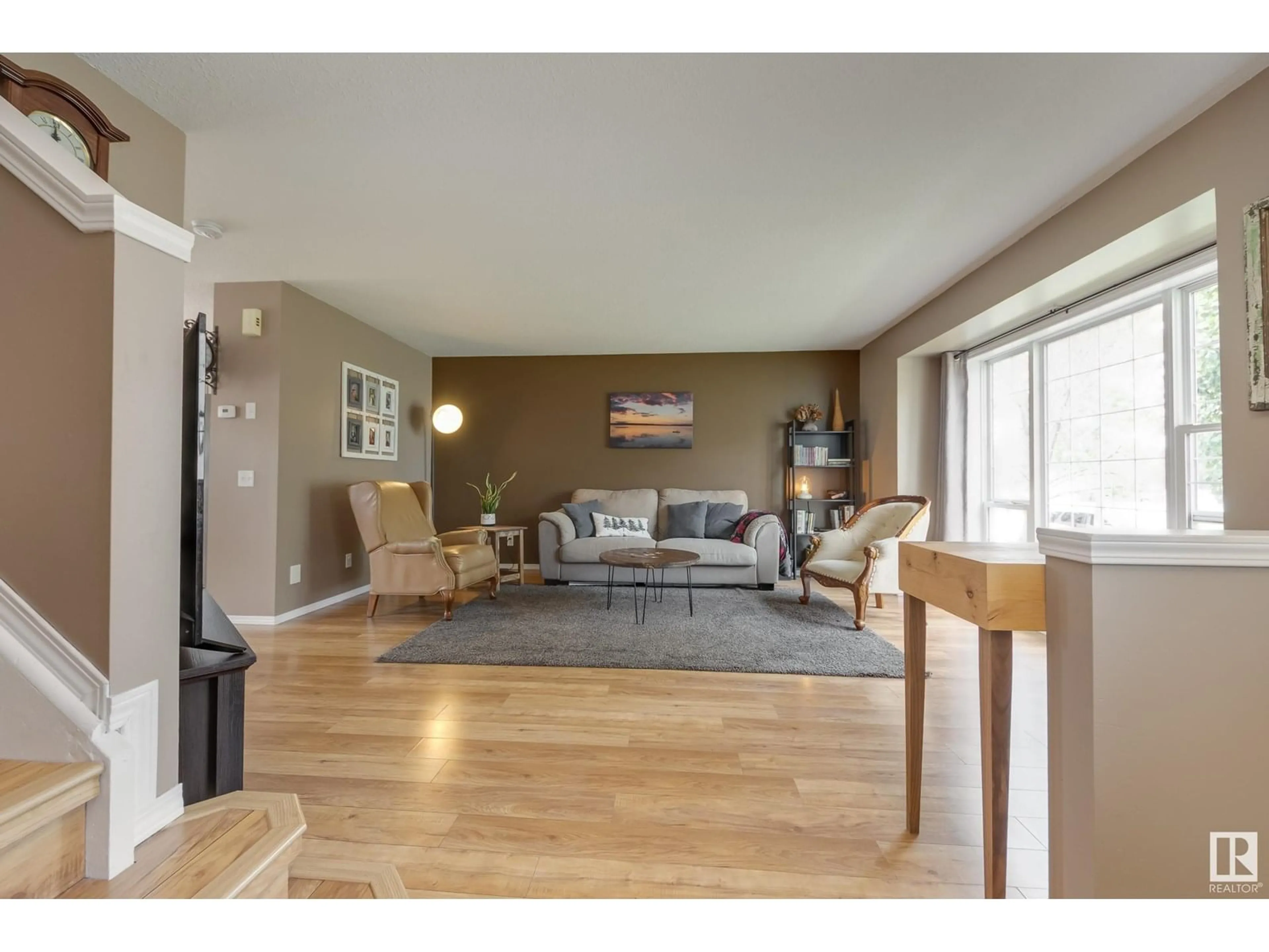 Living room with furniture, wood/laminate floor for 25 HIGHWOOD BV, Devon Alberta T9G2E7