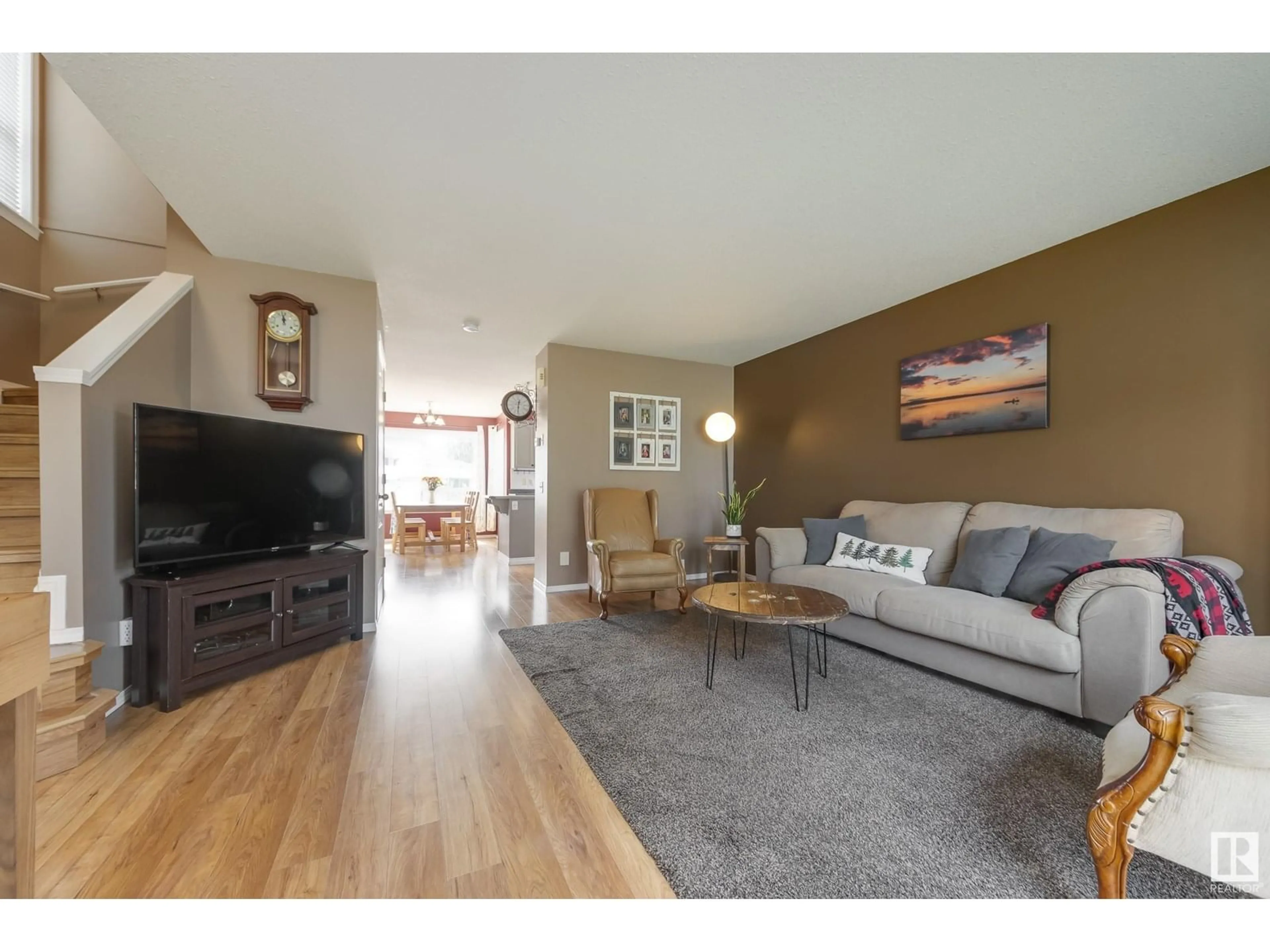 Living room with furniture, wood/laminate floor for 25 HIGHWOOD BV, Devon Alberta T9G2E7