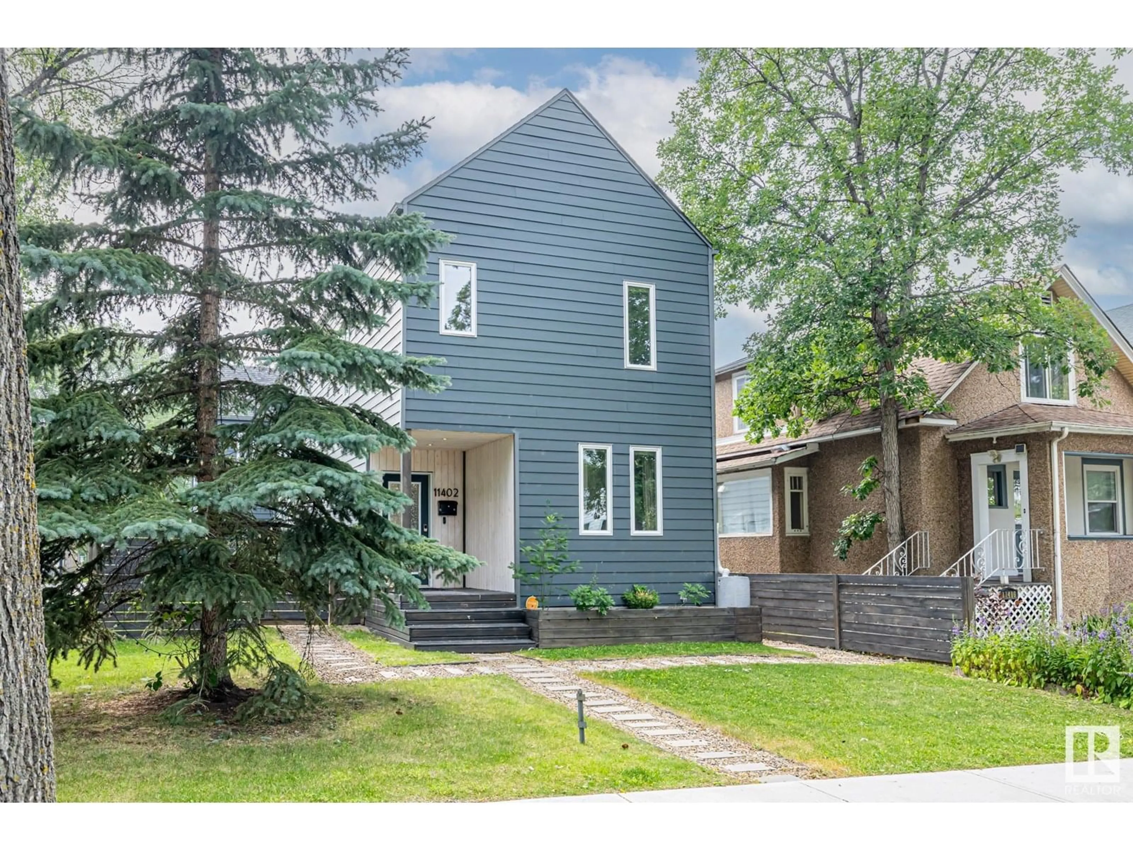 Home with vinyl exterior material, street for NW - 11402 66 ST, Edmonton Alberta T5B1H8